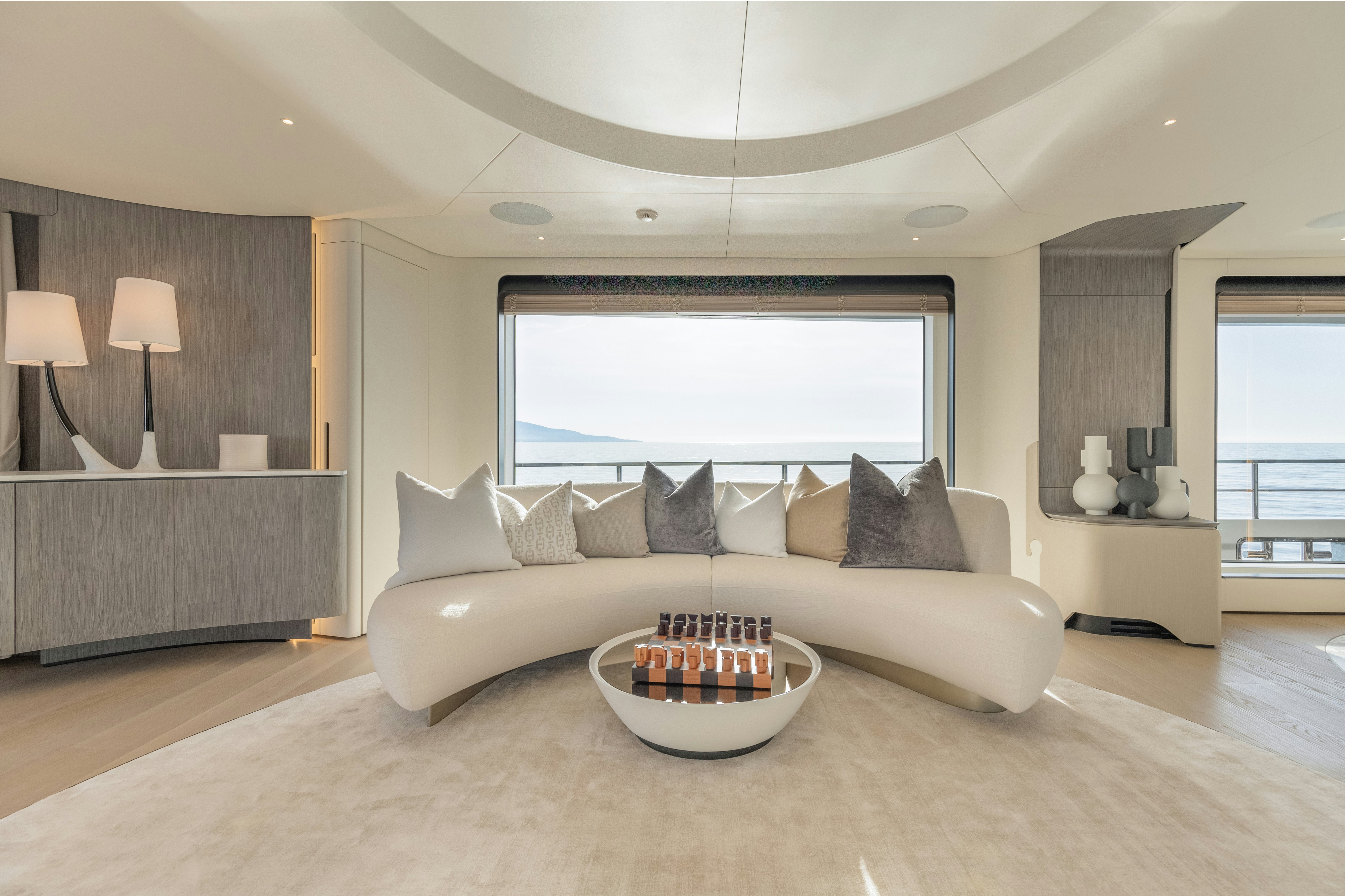 a living room with a large window aboard H Yacht for Sale