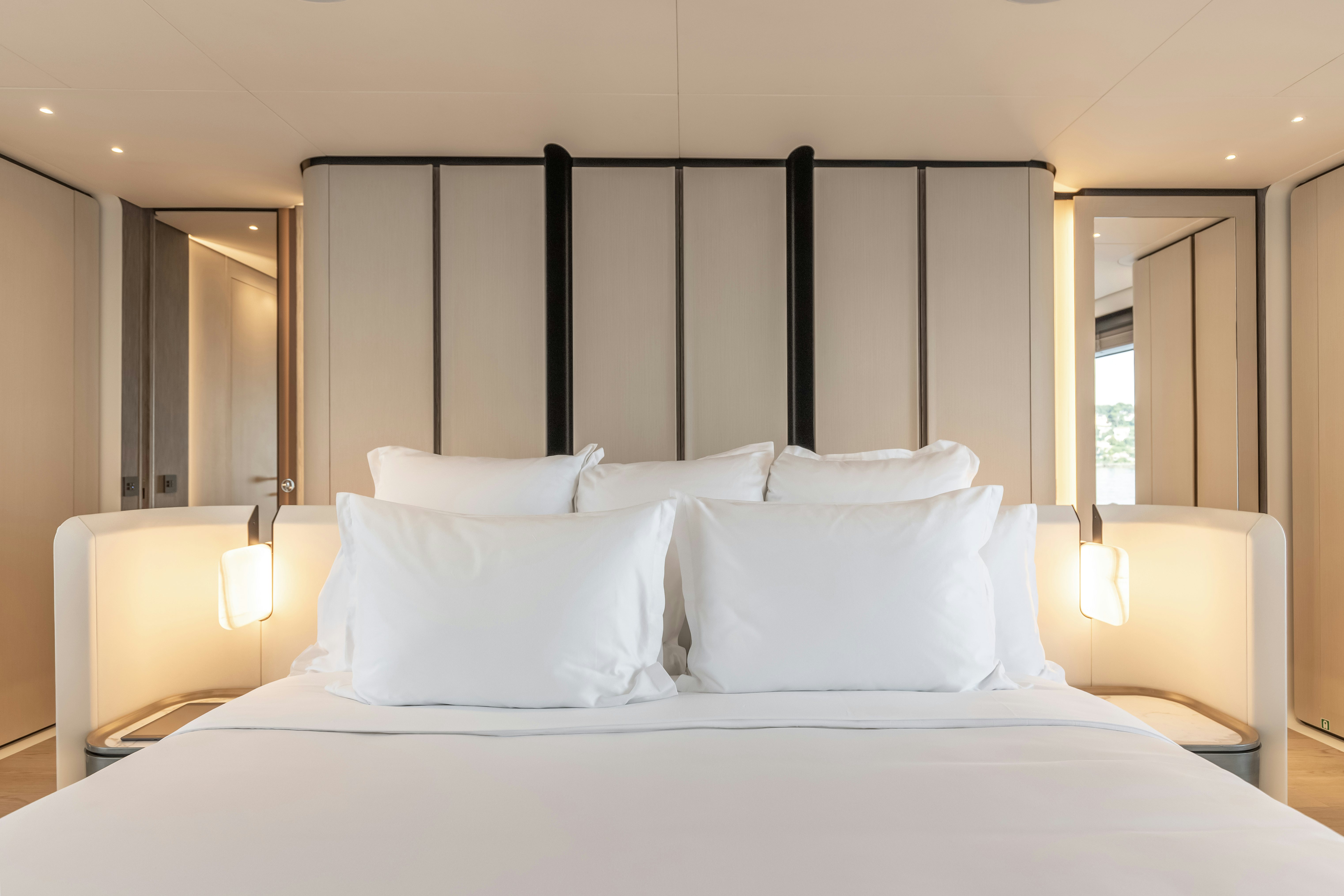 a bed with white sheets aboard H Yacht for Sale