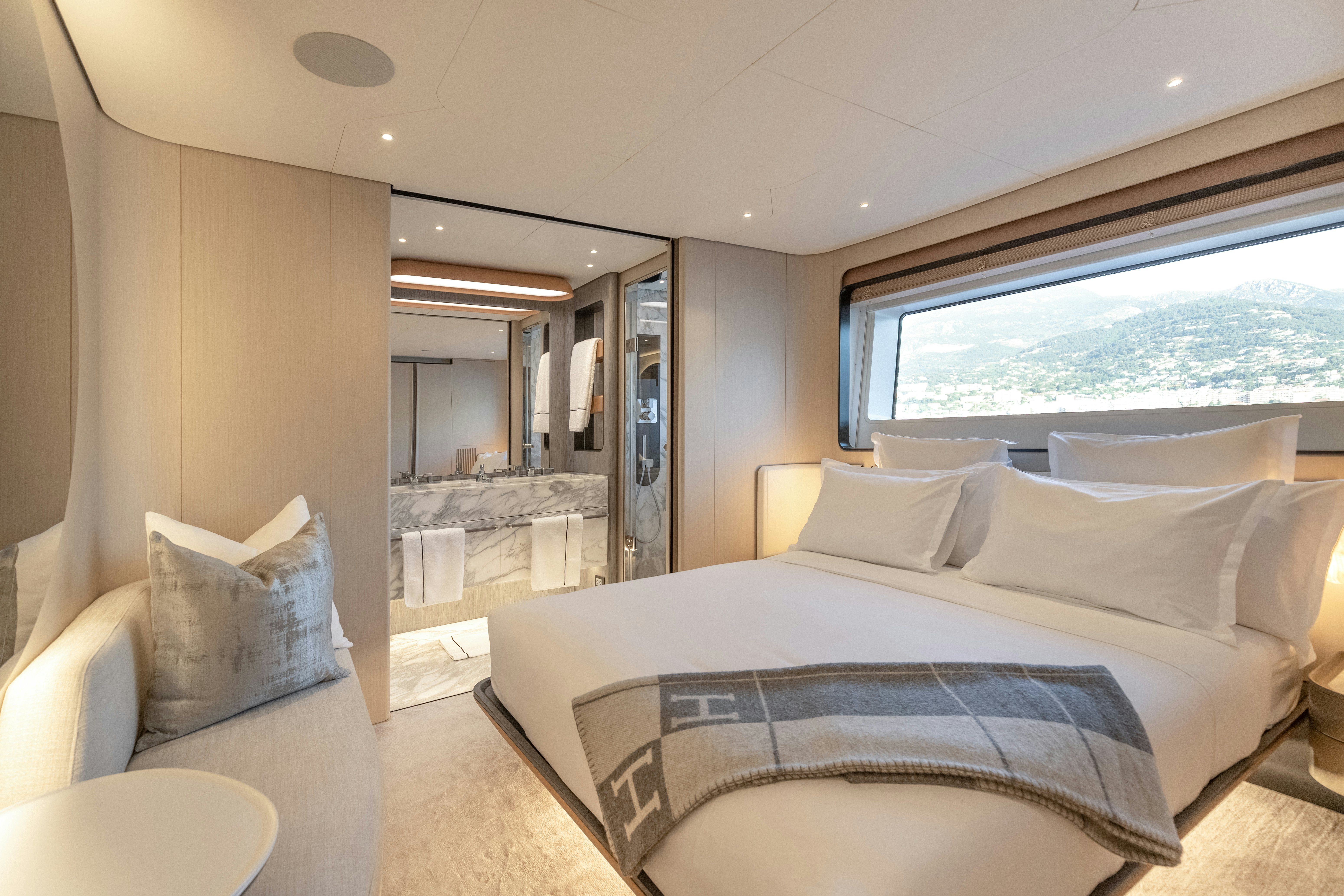 a large bedroom with a large bed aboard H Yacht for Sale