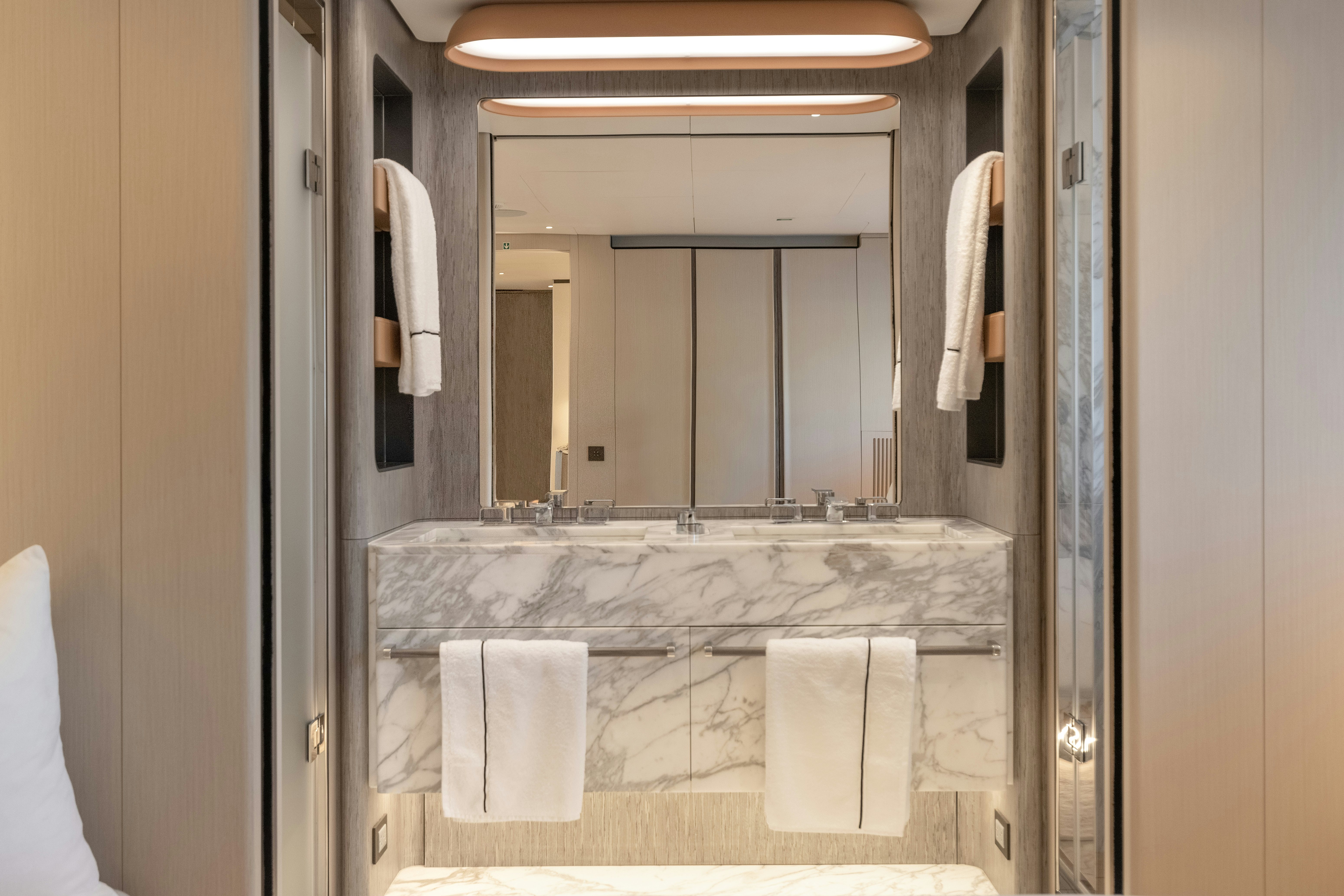 a bathroom with a large mirror aboard H Yacht for Sale