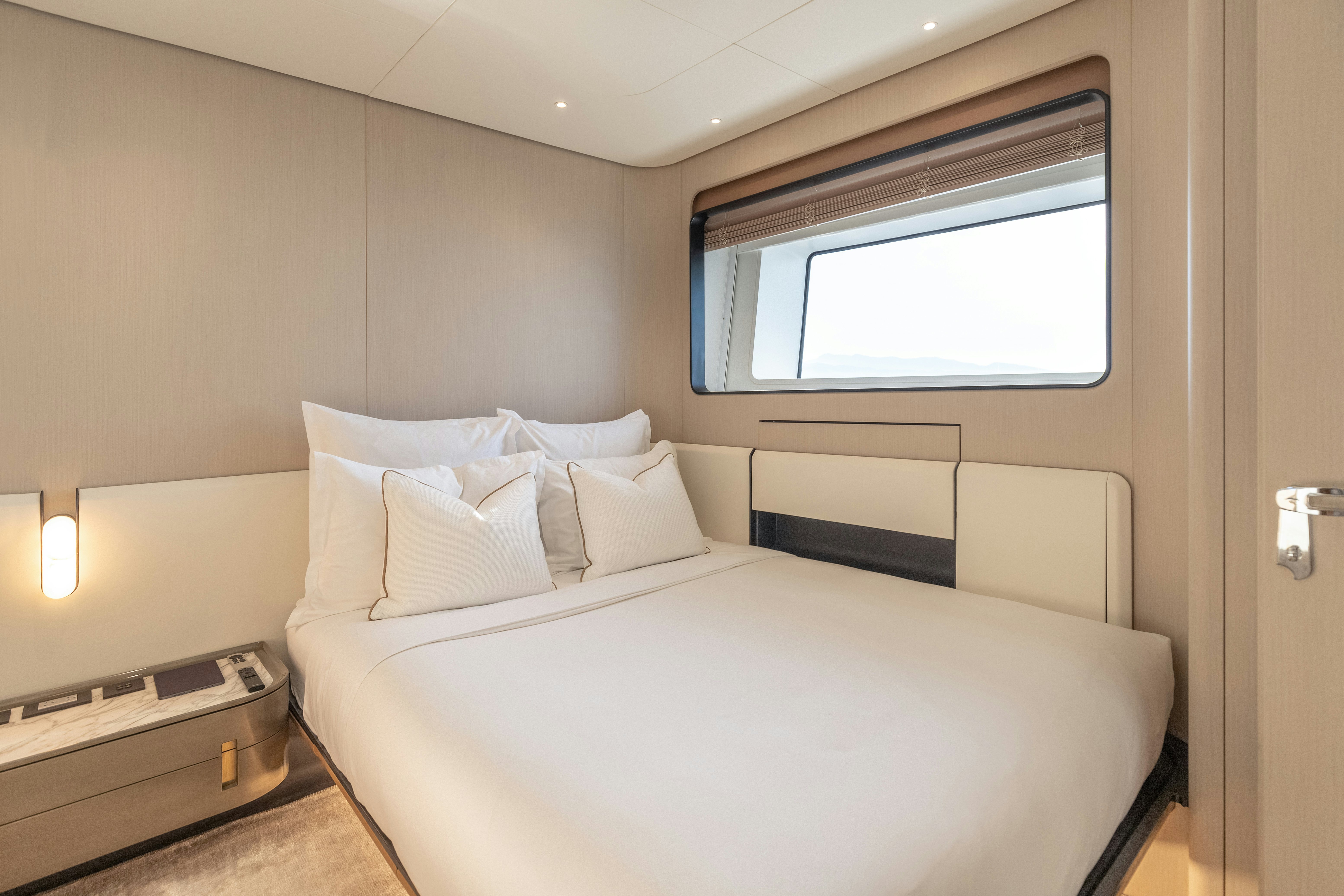 a bed with white sheets aboard H Yacht for Sale