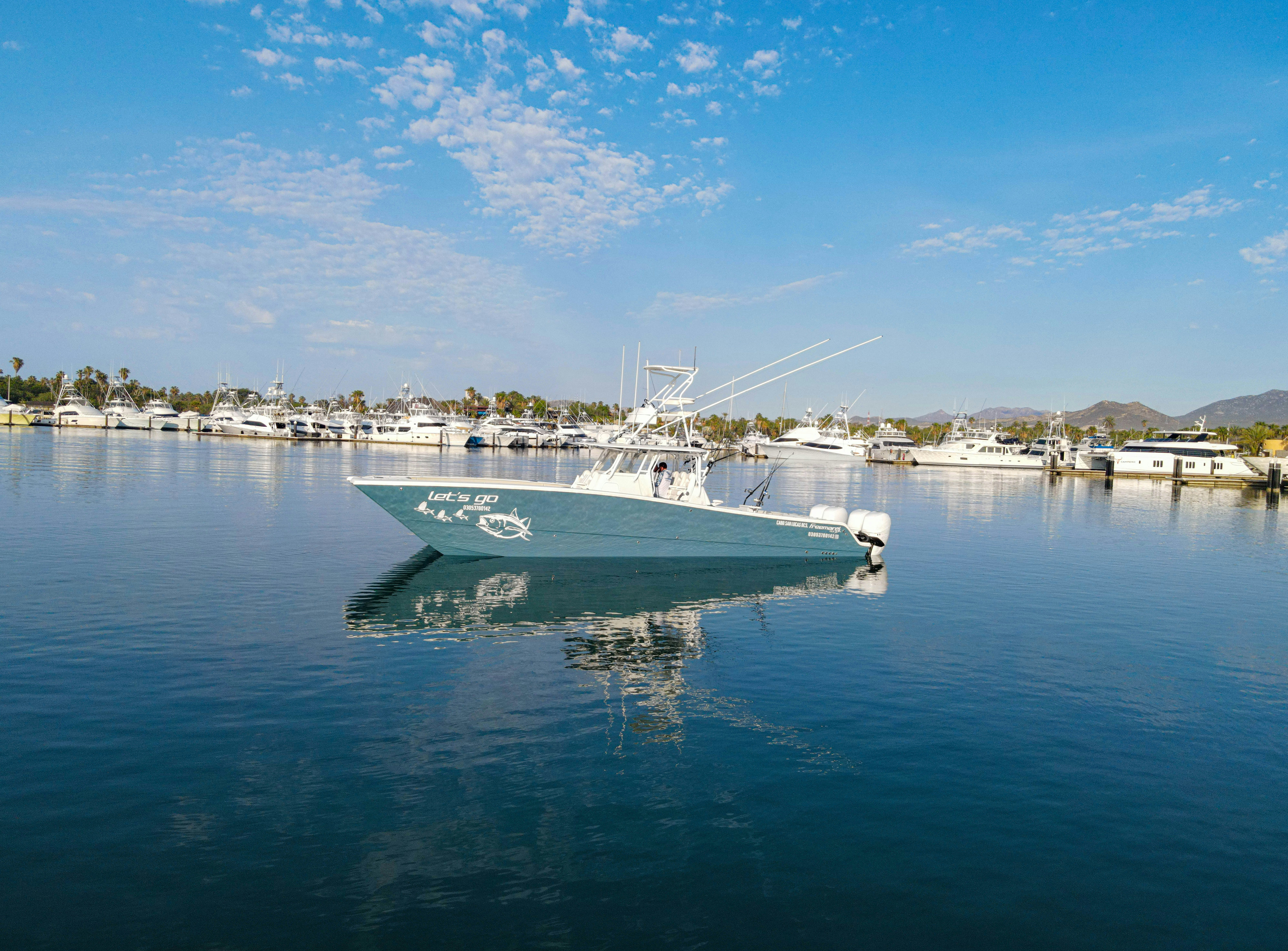 a large white boat in the water aboard LET'S GO Yacht for Sale