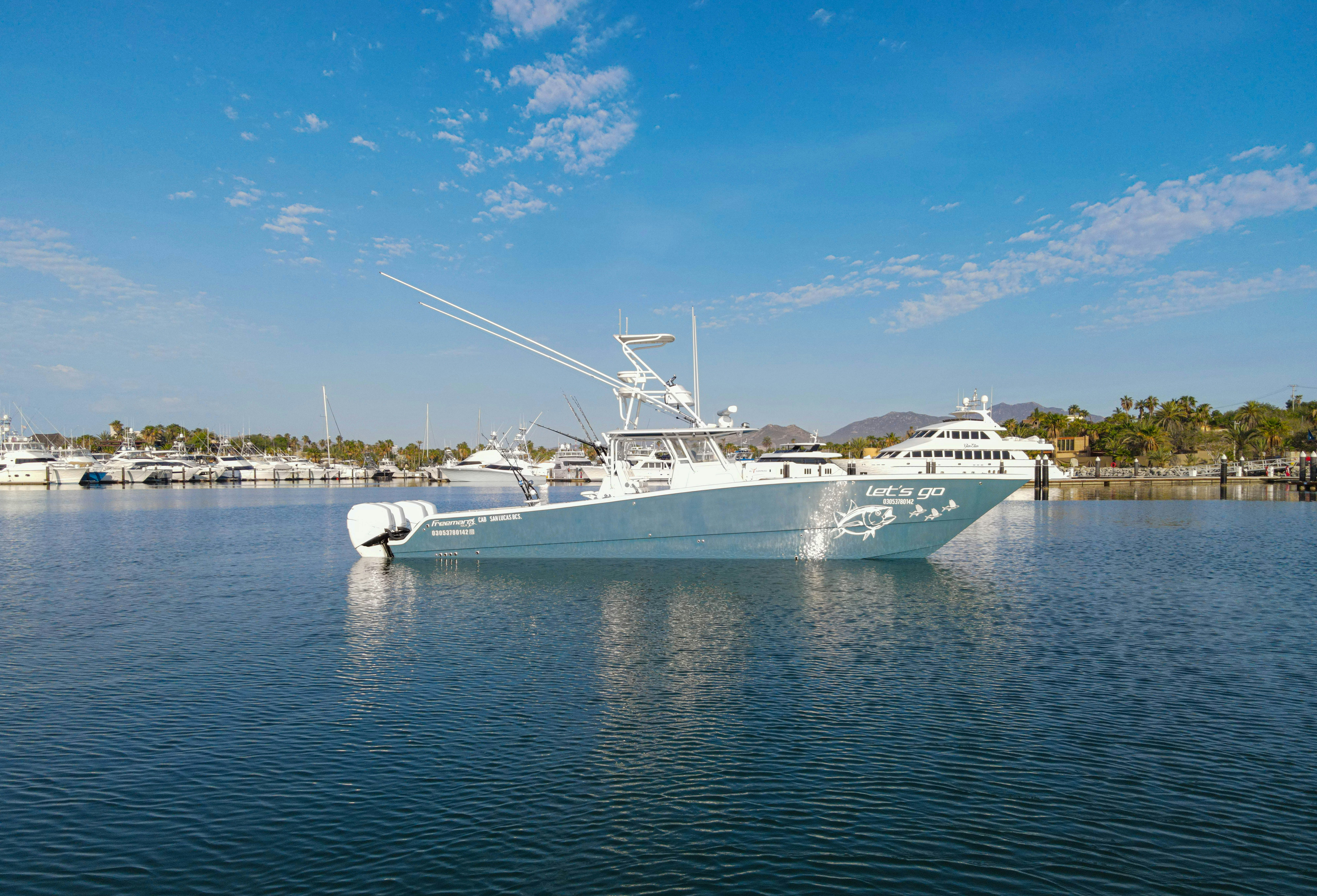 a large white boat in the water aboard LET'S GO Yacht for Sale