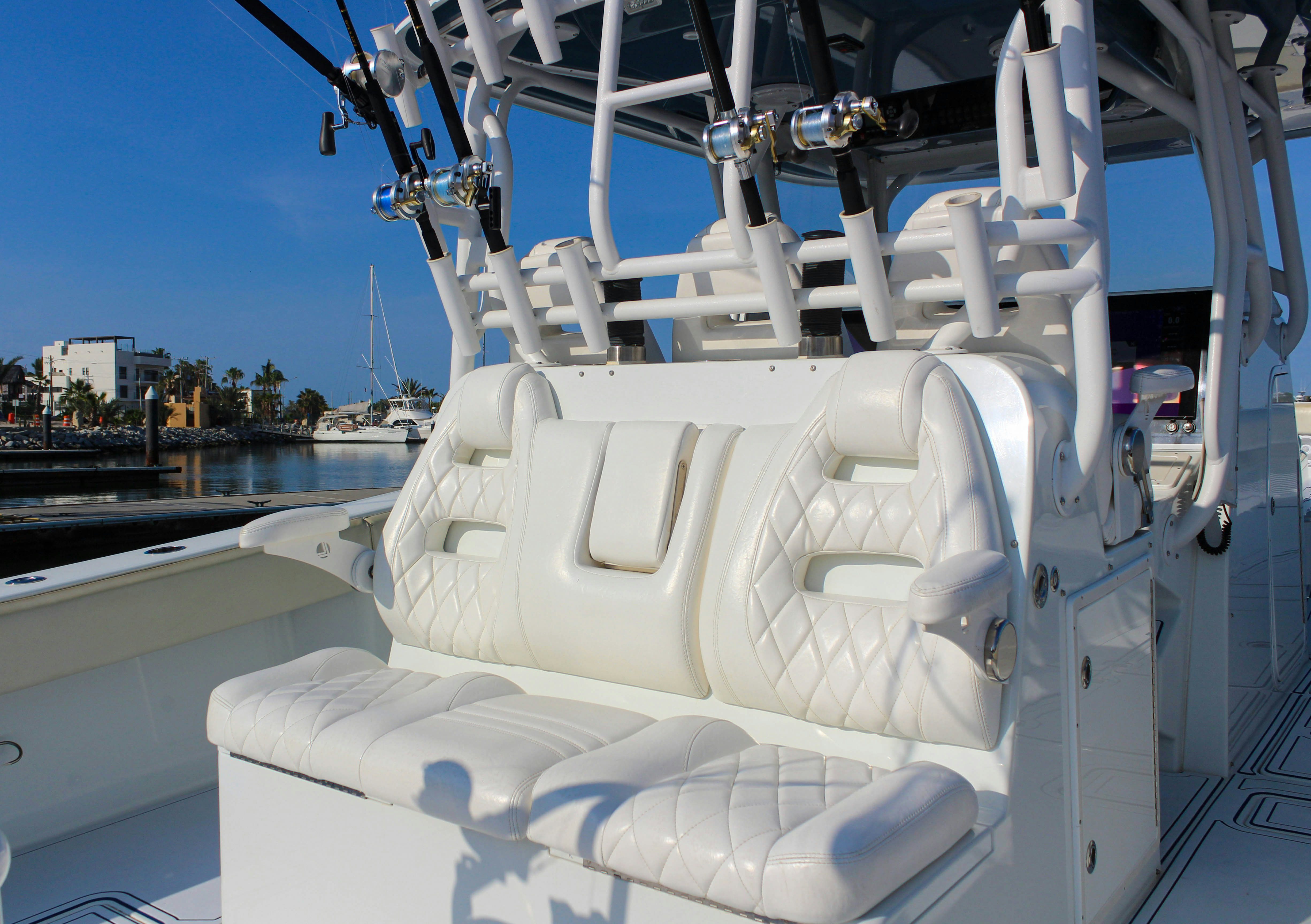 a white boat on a body of water aboard LET'S GO Yacht for Sale