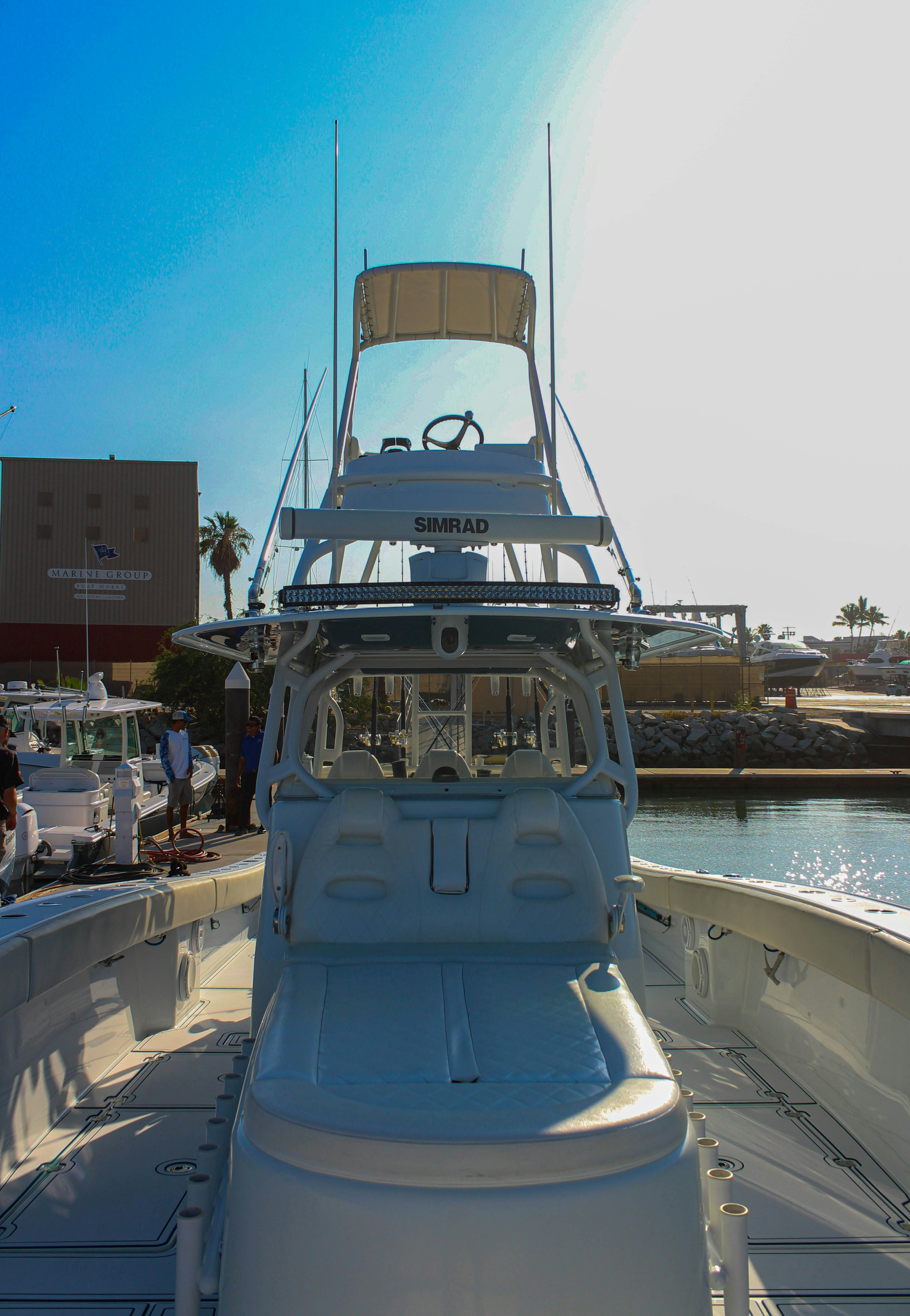 a large white boat in a harbor aboard LET'S GO Yacht for Sale