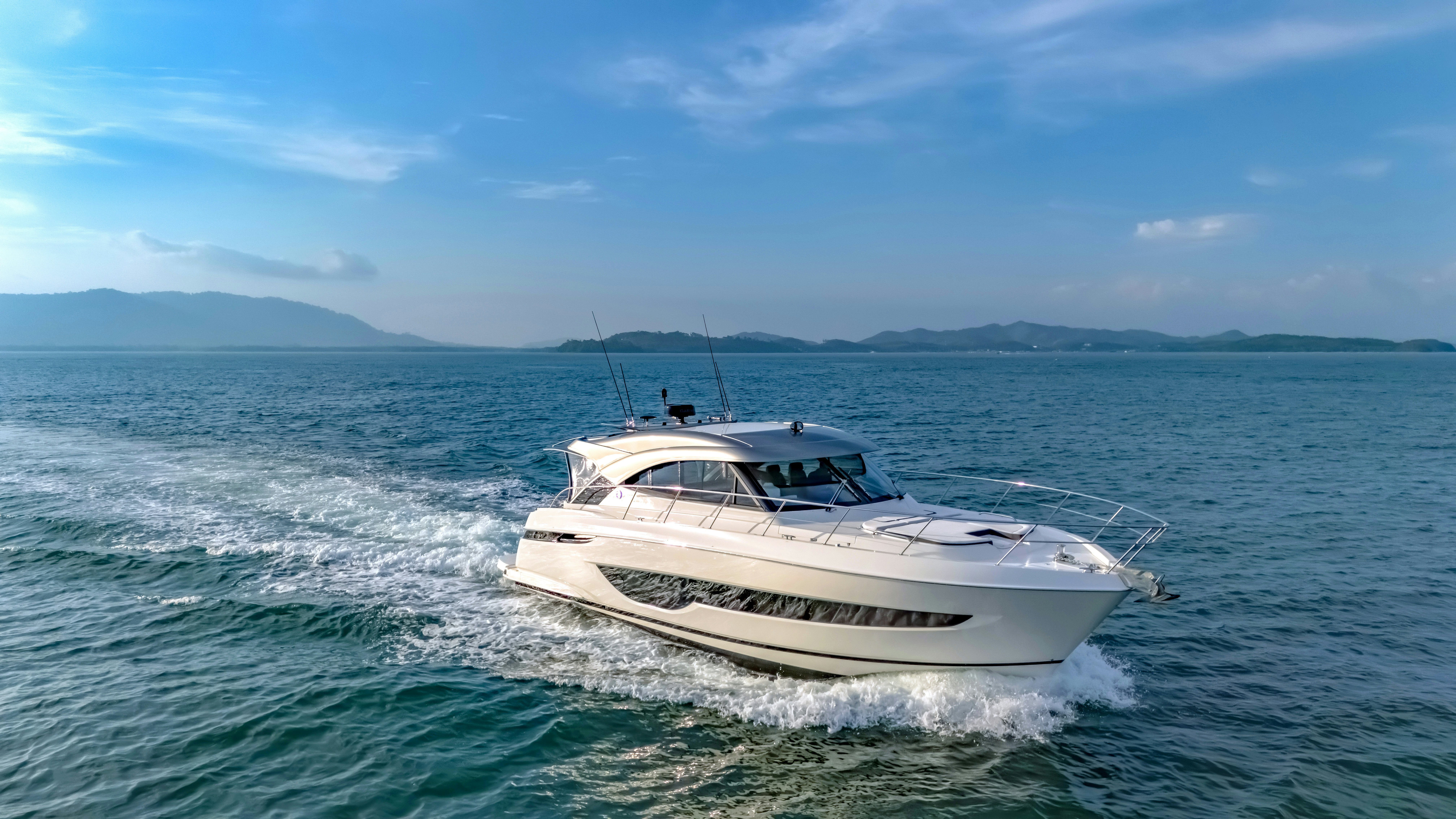 a white boat in the water aboard RIVIERA 4600 SPORT YACHT Yacht for Sale