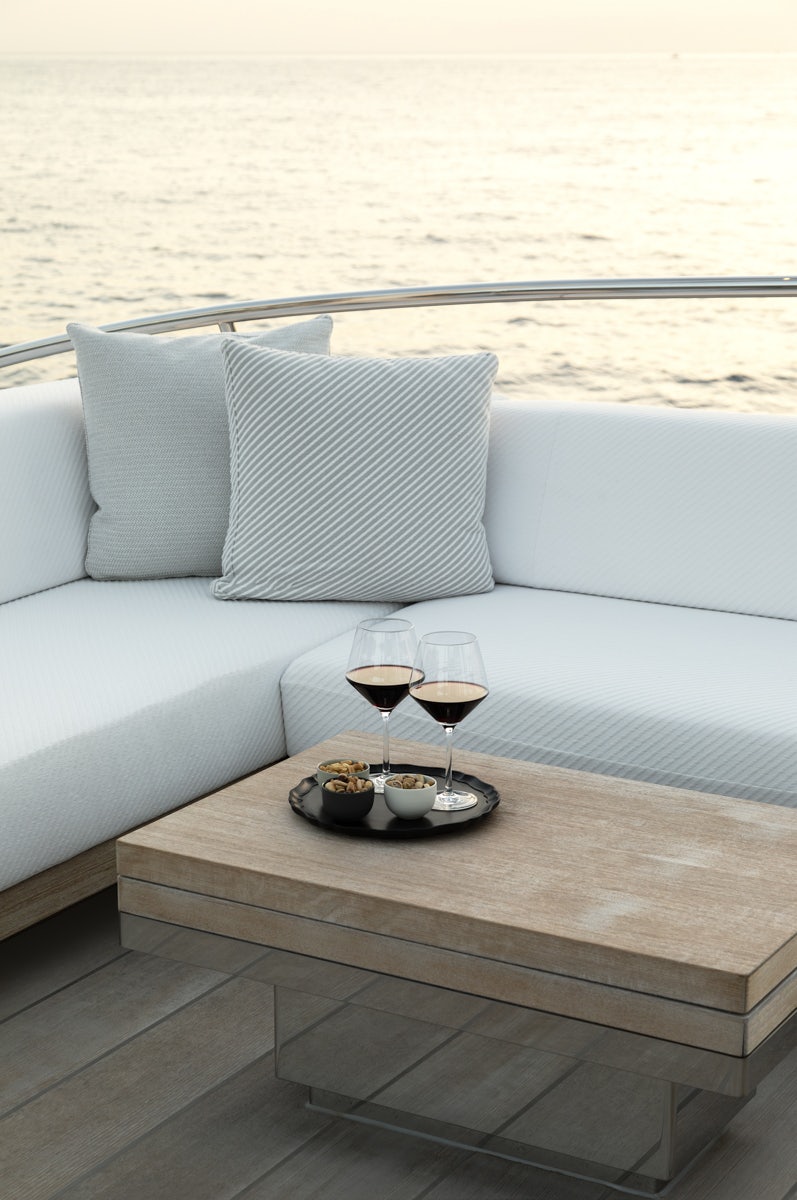 a glass of wine and a tray of food on a table aboard TWIZZLE Yacht for Charter