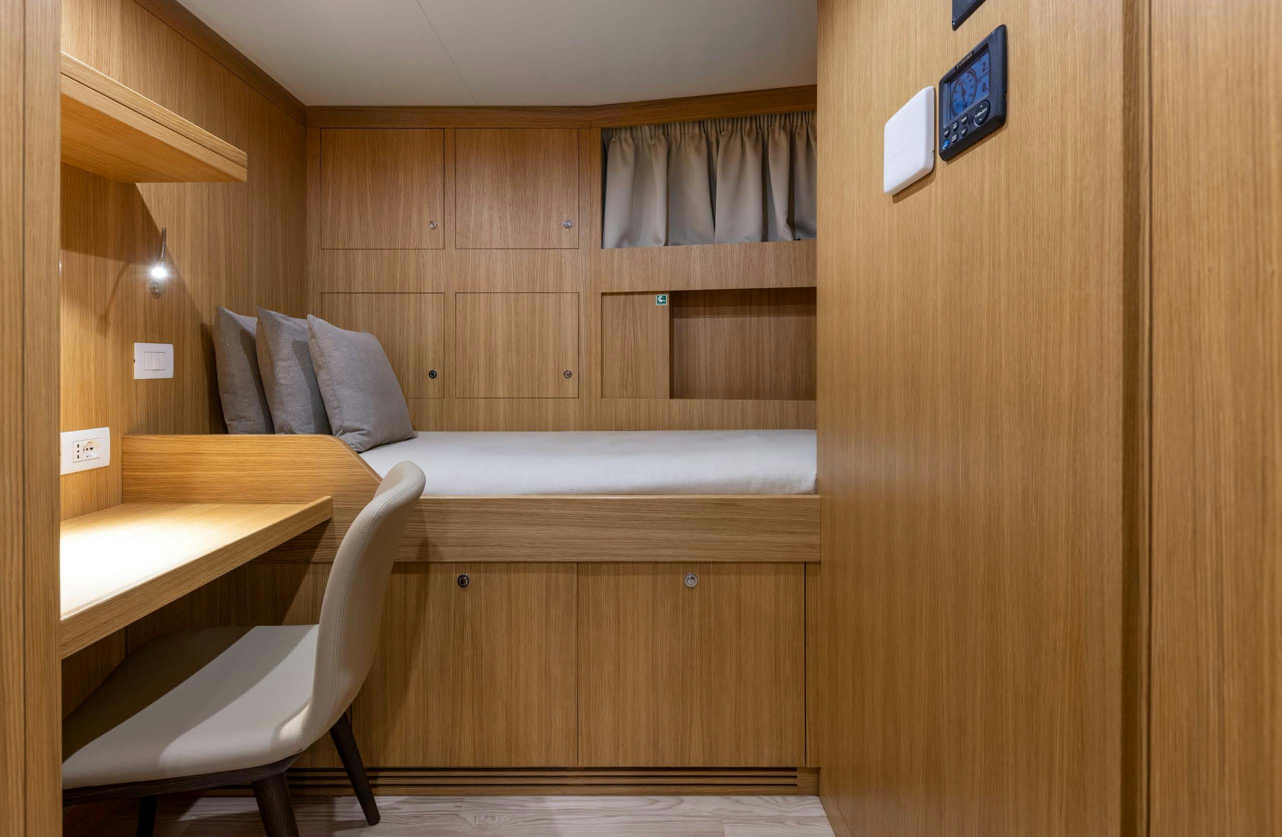 a room with a bed and a desk aboard IRYNA II Yacht for Sale