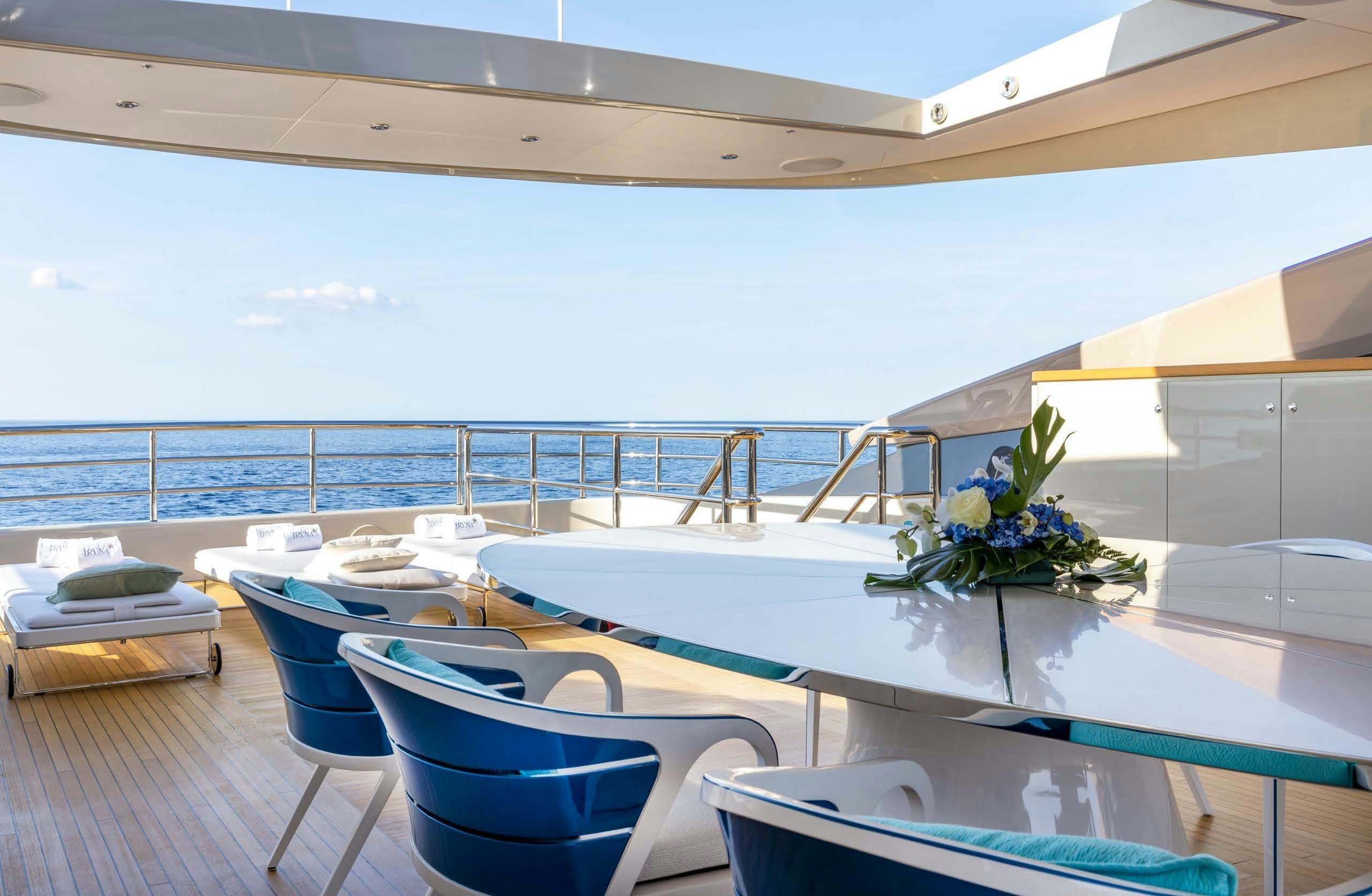 a room with a table and chairs aboard IRYNA II Yacht for Sale