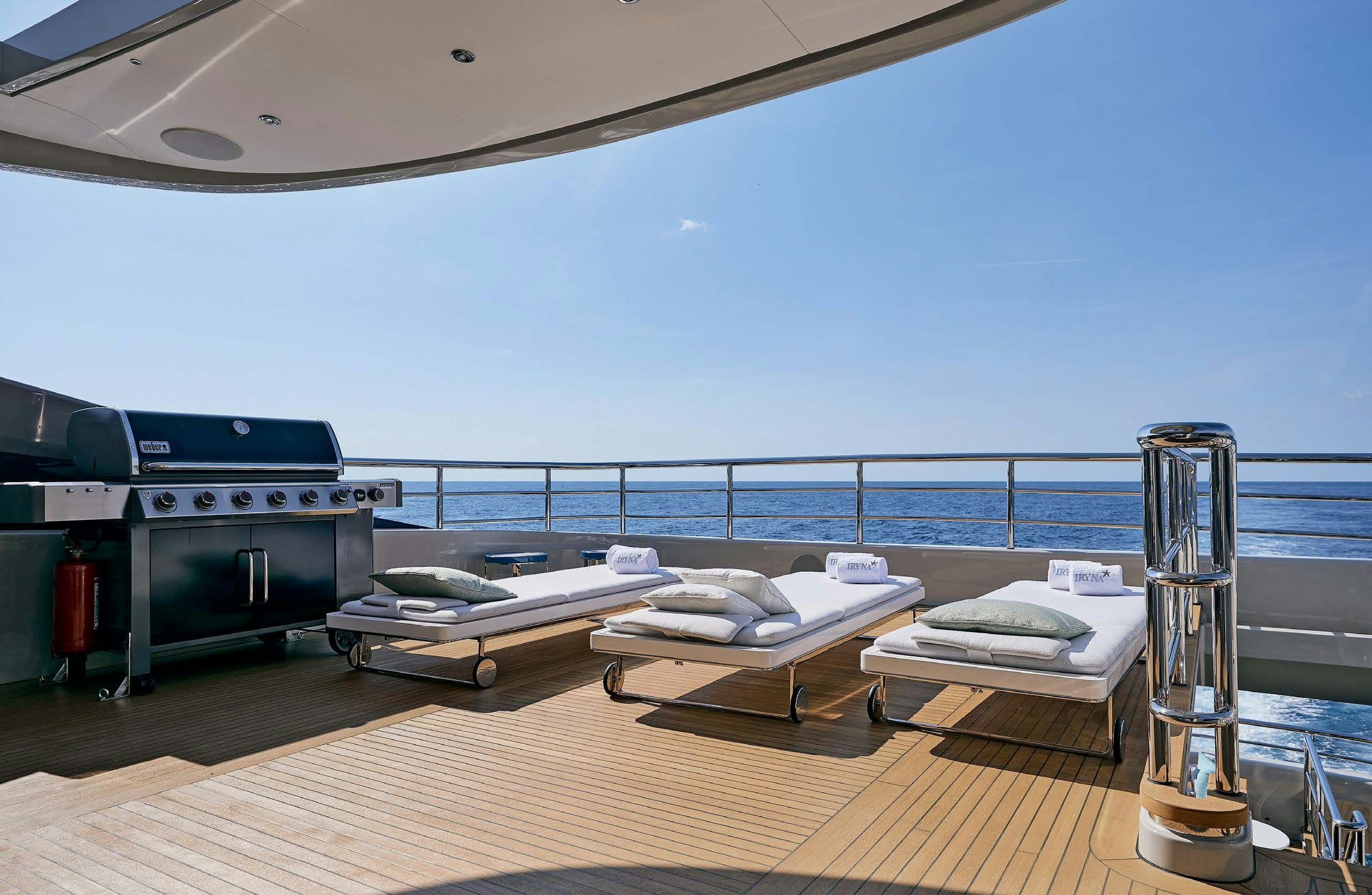 a bed and a bed on a deck aboard IRYNA II Yacht for Sale