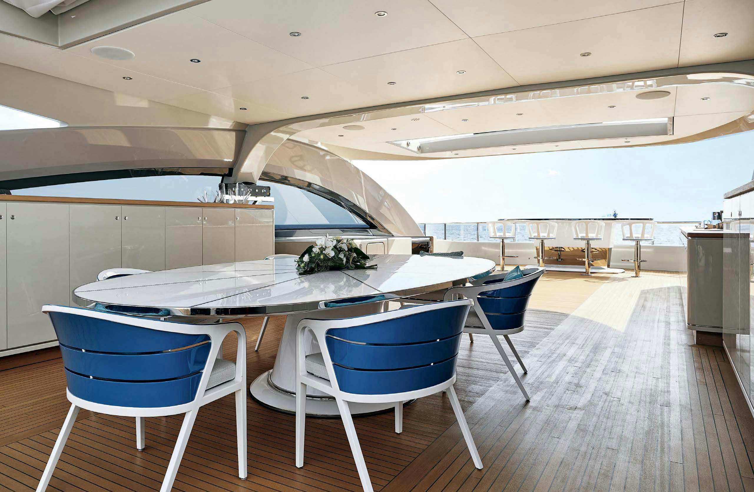 a room with tables and chairs aboard IRYNA II Yacht for Sale