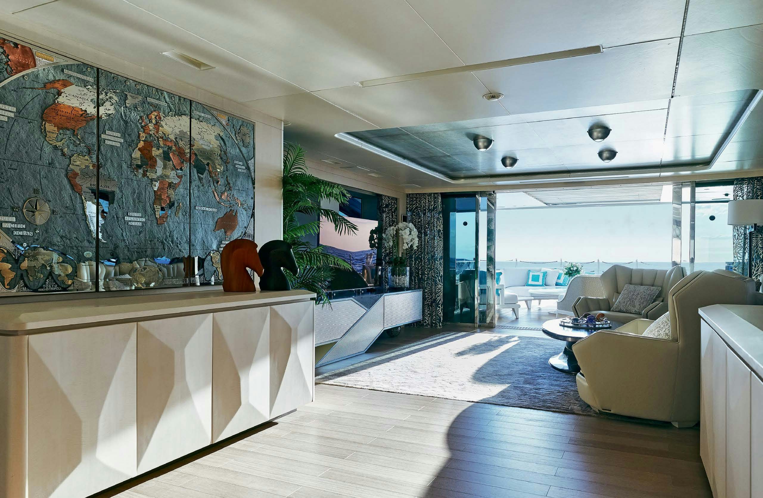 a room with a large window and a couch and a table aboard IRYNA II Yacht for Sale