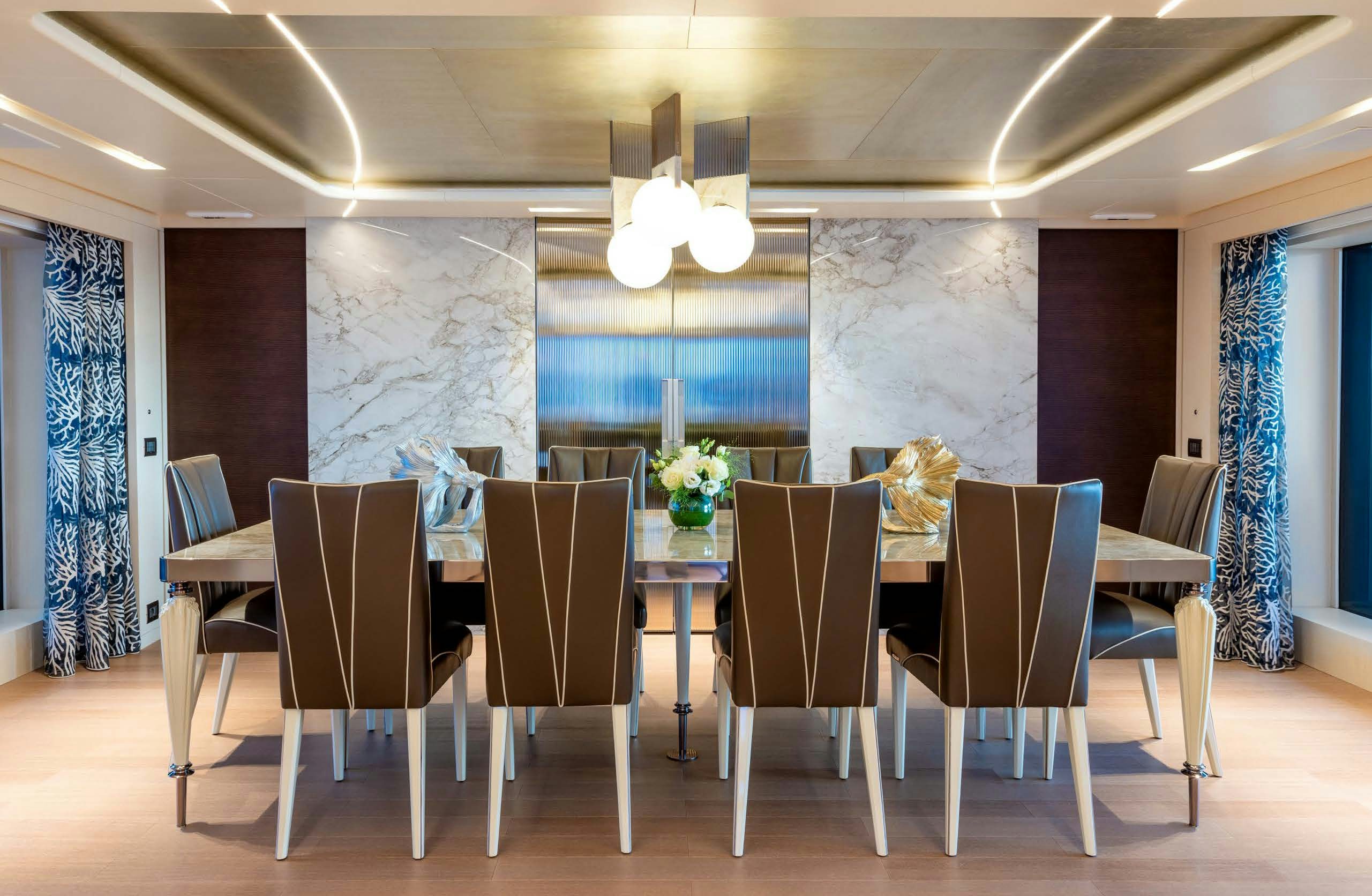 a room with a table and chairs aboard IRYNA II Yacht for Sale