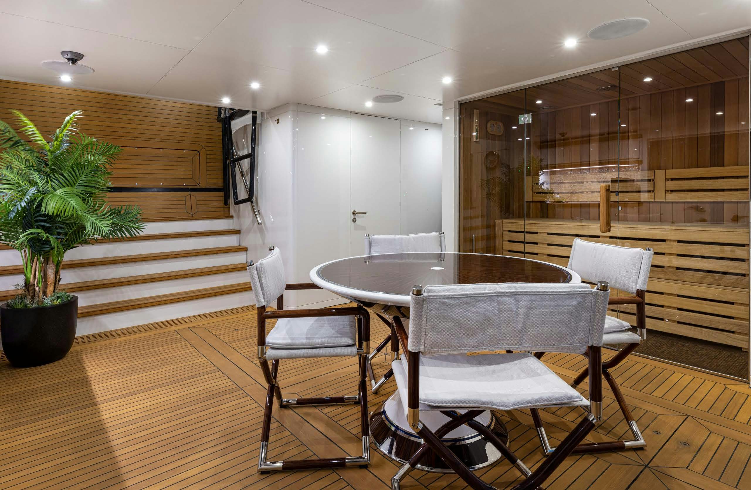 a table and chairs in a room aboard IRYNA II Yacht for Sale