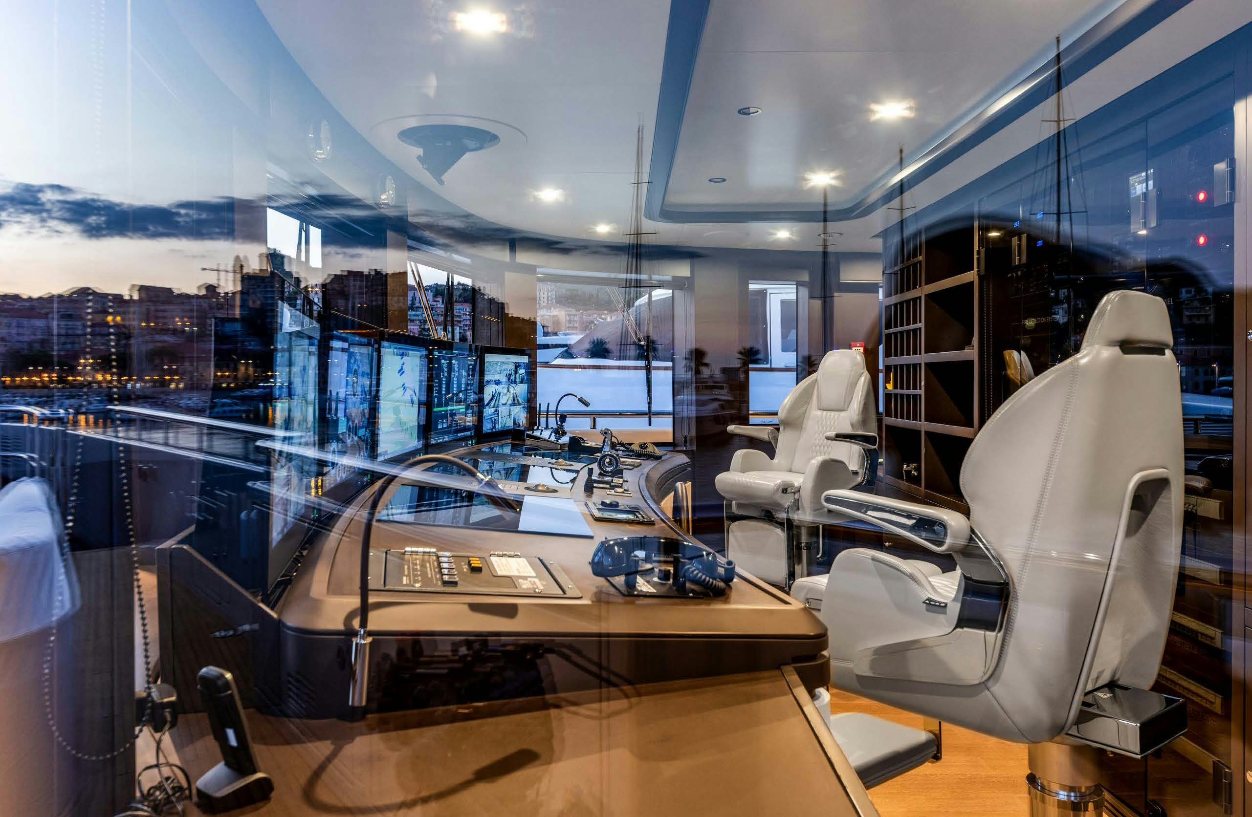 a room with a large display of computers and chairs aboard IRYNA II Yacht for Sale