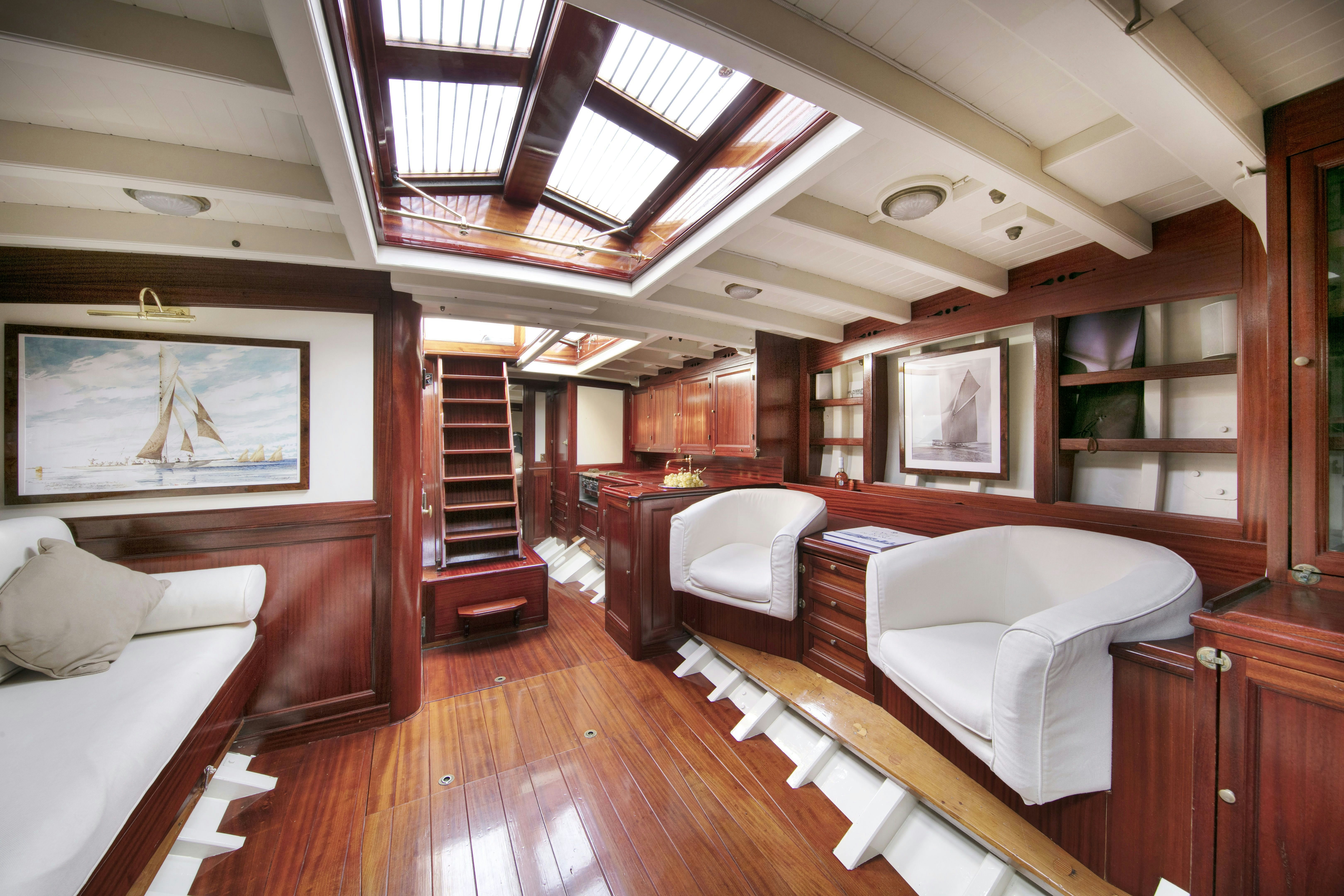 a room with a bed and a couch aboard MARISKA Yacht for Sale