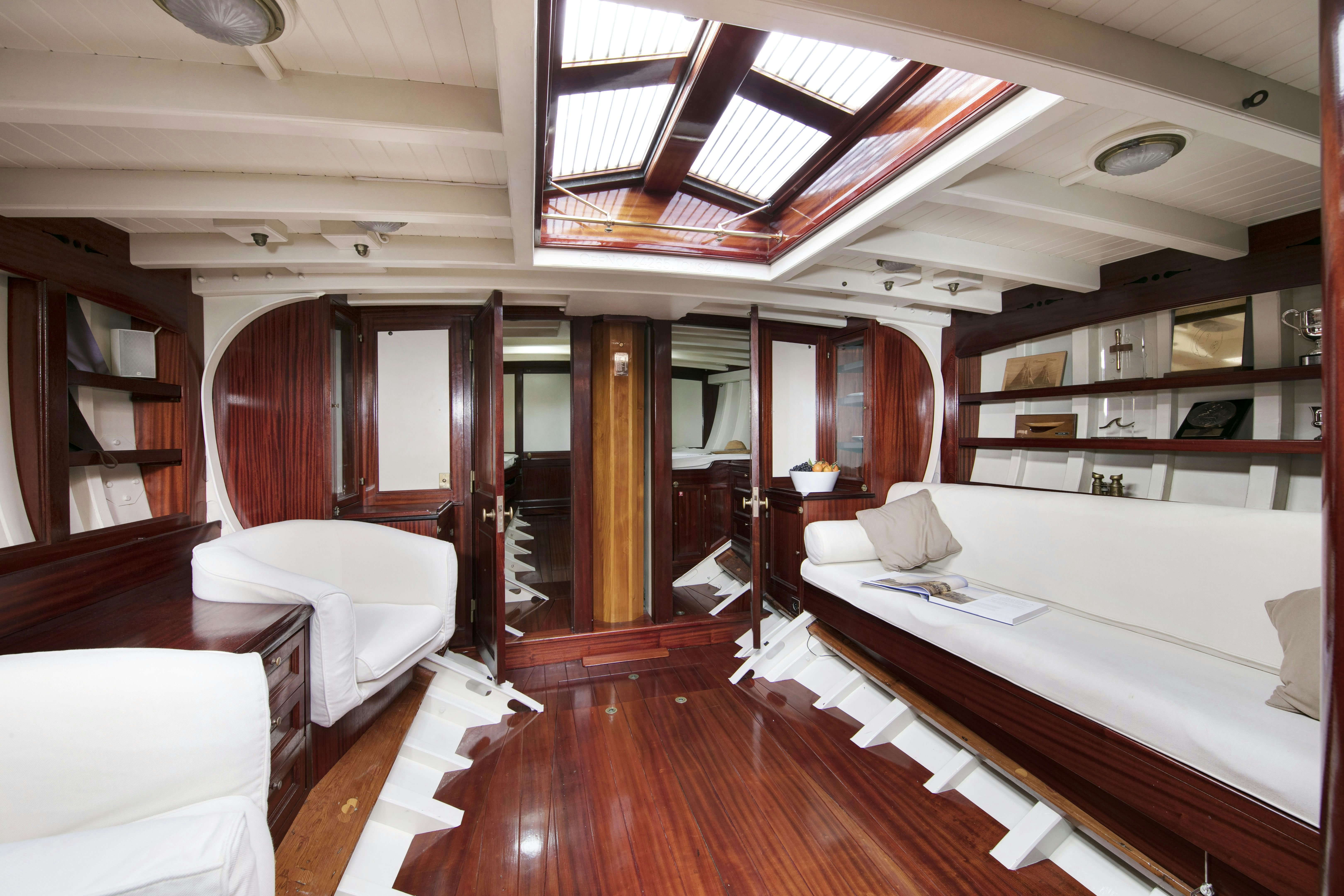 a room with a bed and a table aboard MARISKA Yacht for Sale