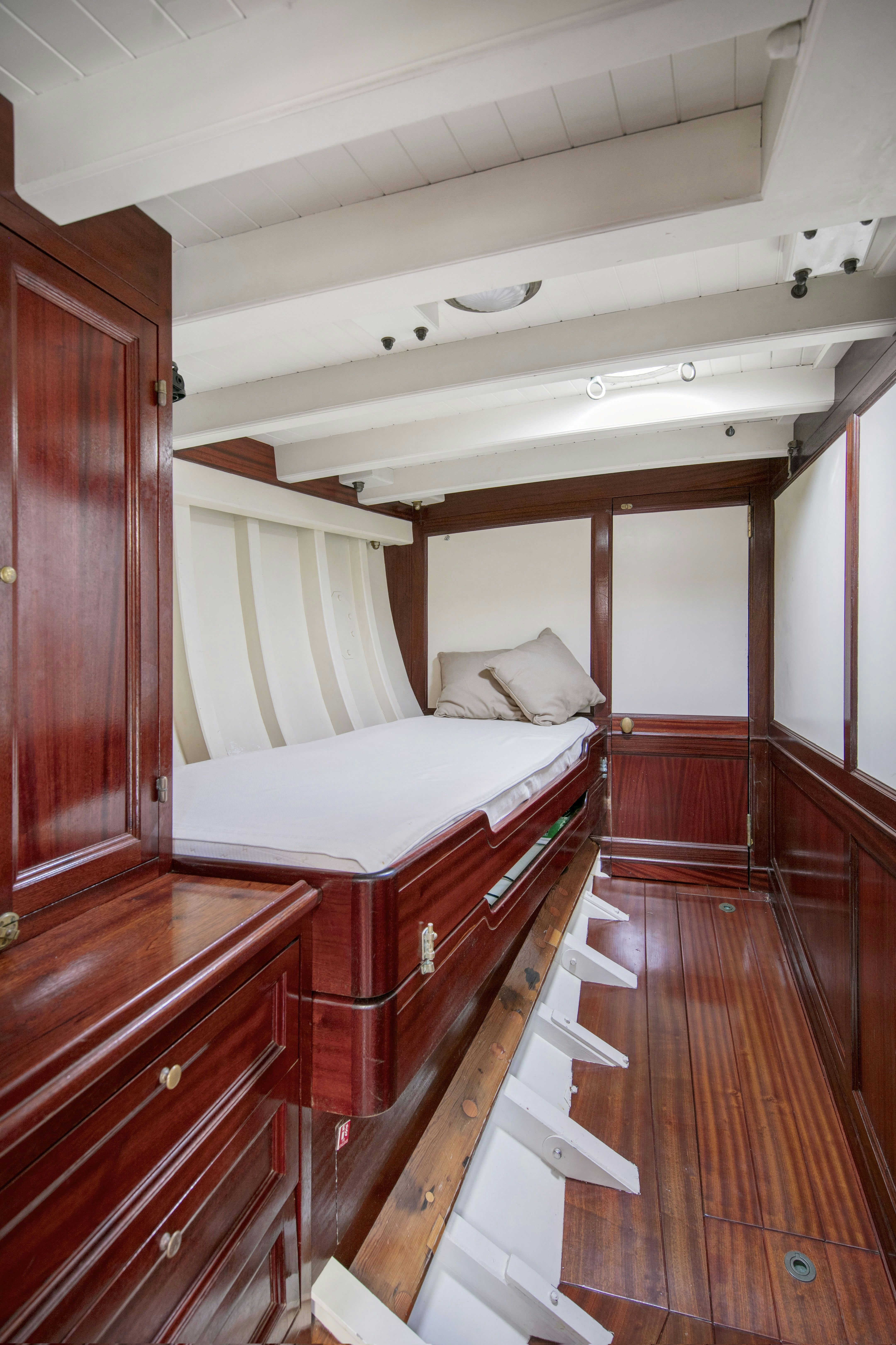 a room with a bed and a wood door aboard MARISKA Yacht for Sale