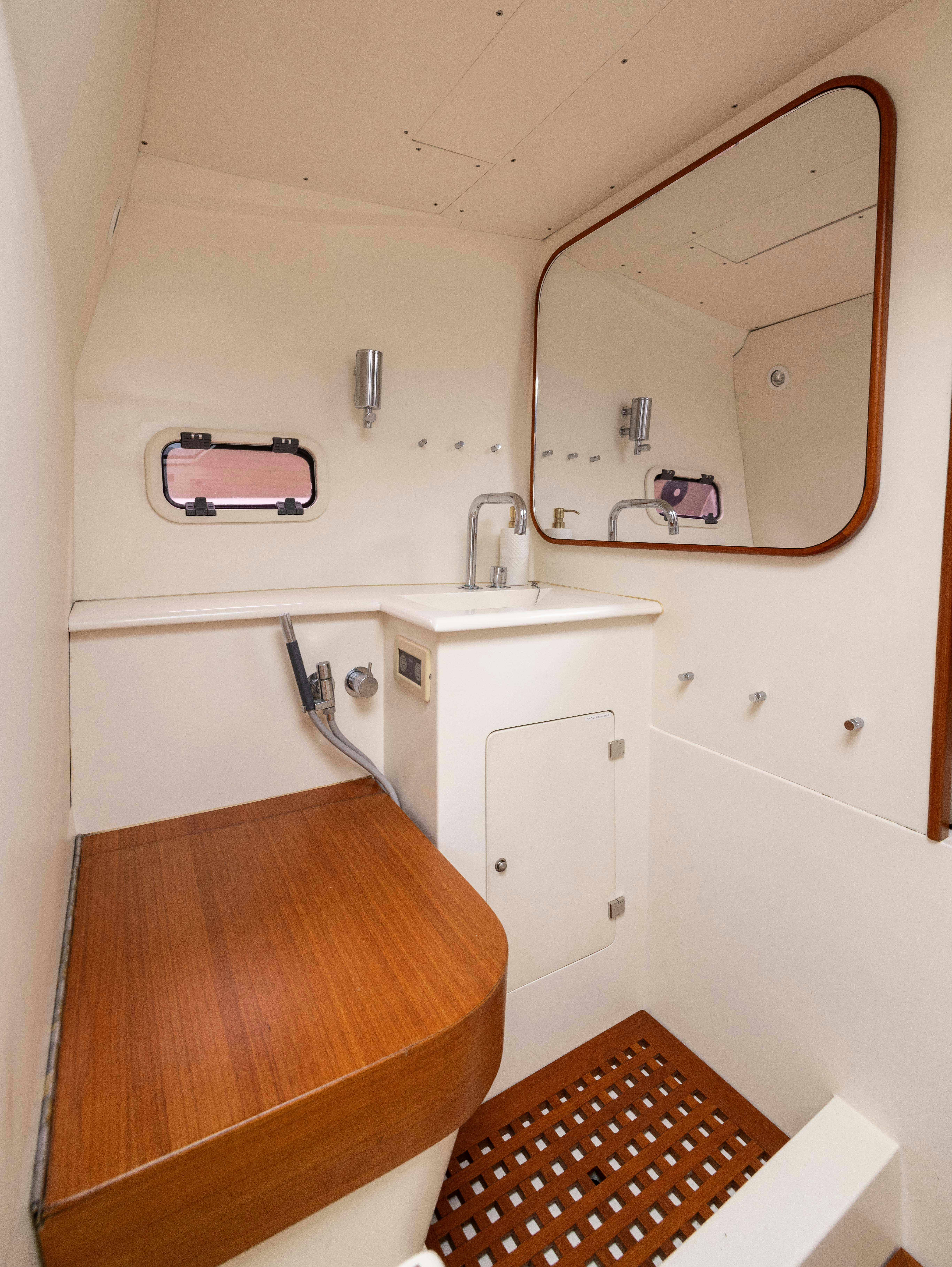 a bathroom with a mirror aboard FAN SEA II Yacht for Sale