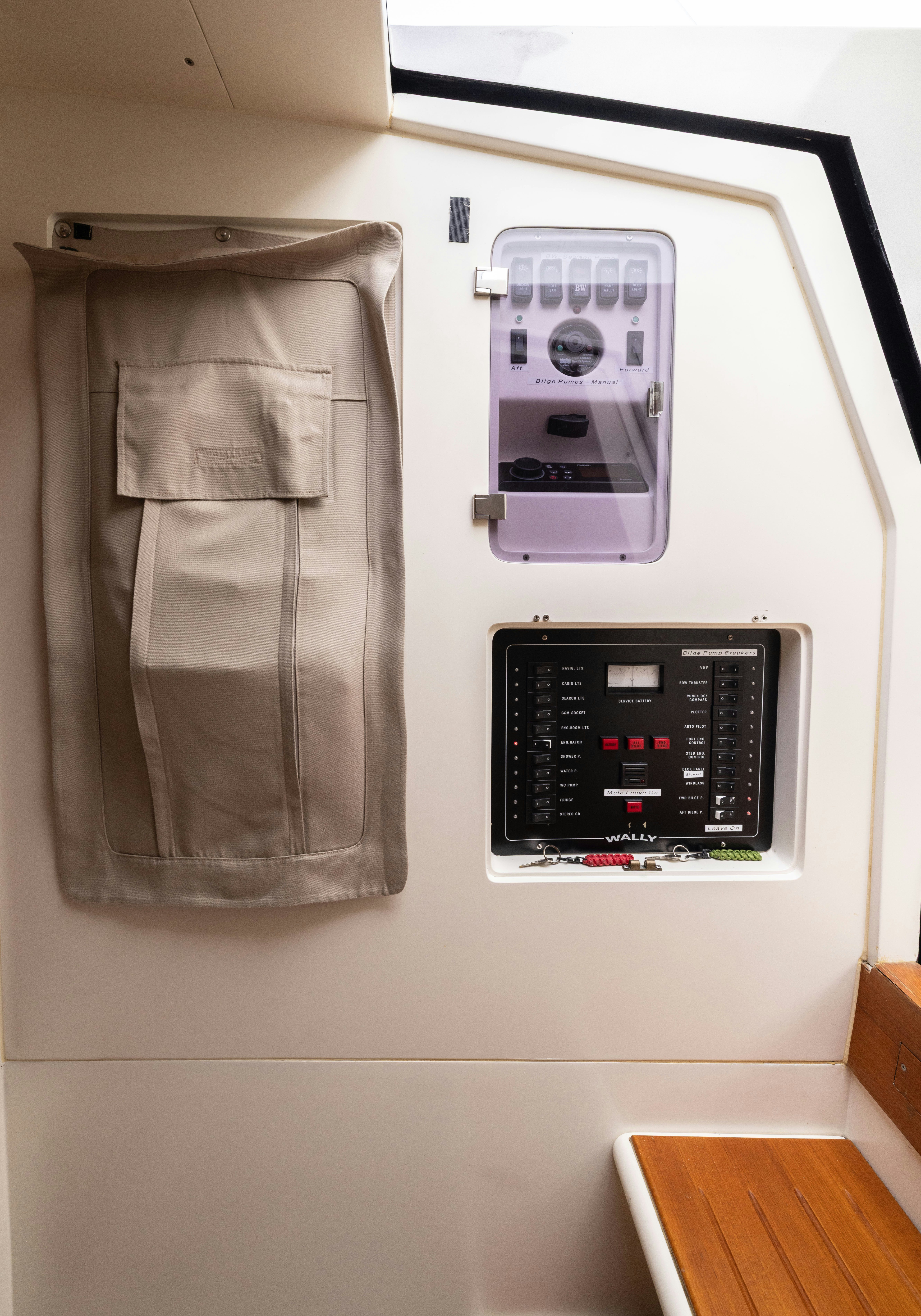 a wall with a phone and a watch on it aboard FAN SEA II Yacht for Sale