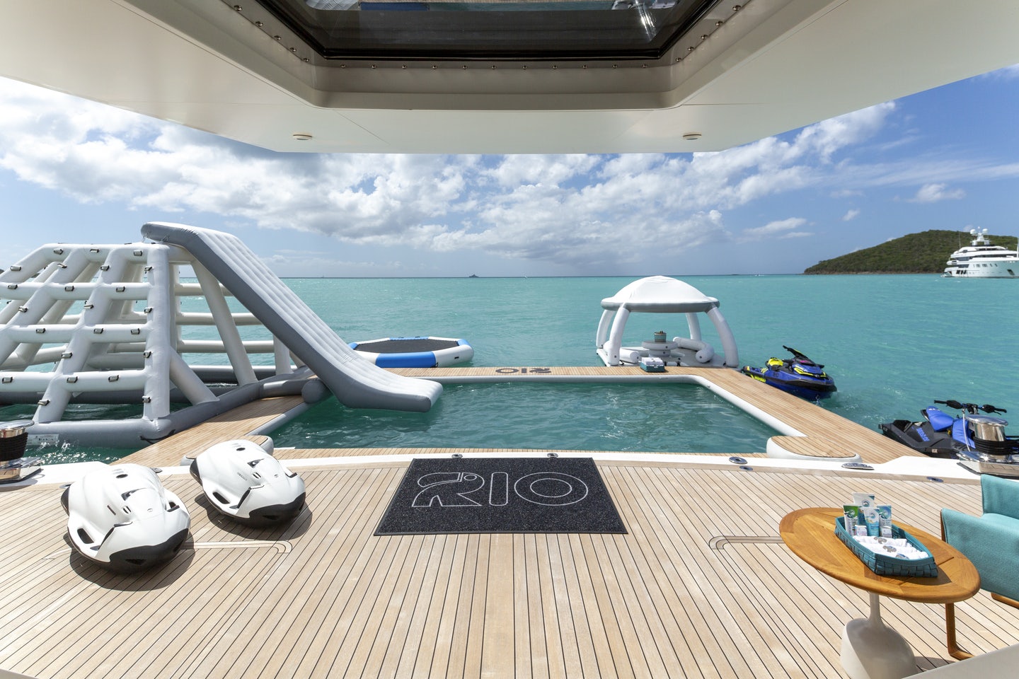 a deck with a pool and boats on it aboard RIO Yacht for Charter