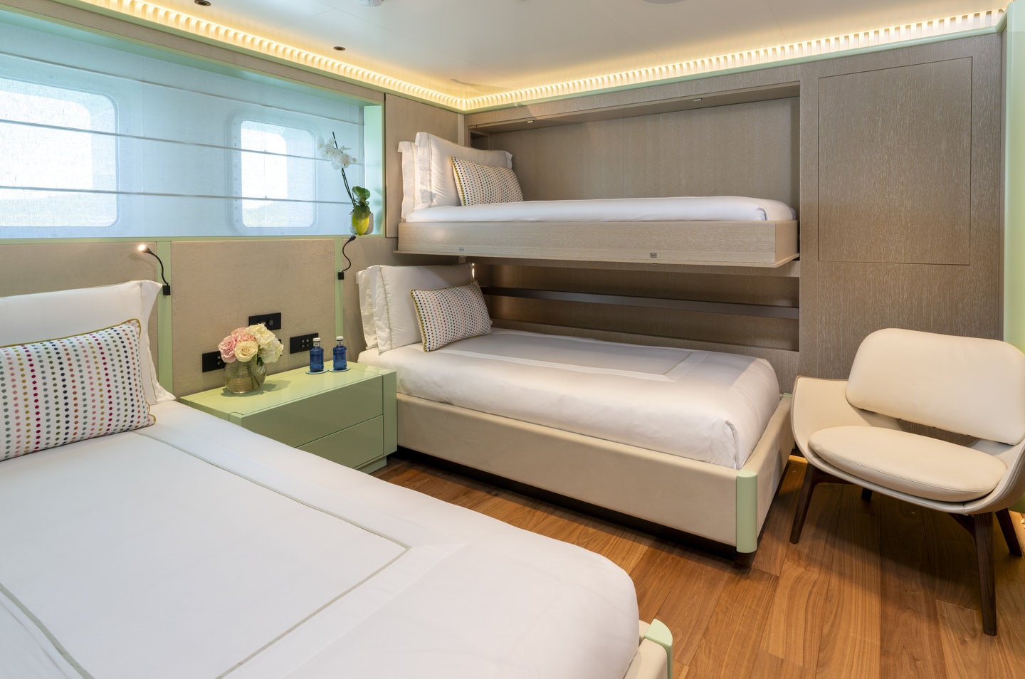 a room with a bed and a chair aboard RIO Yacht for Charter