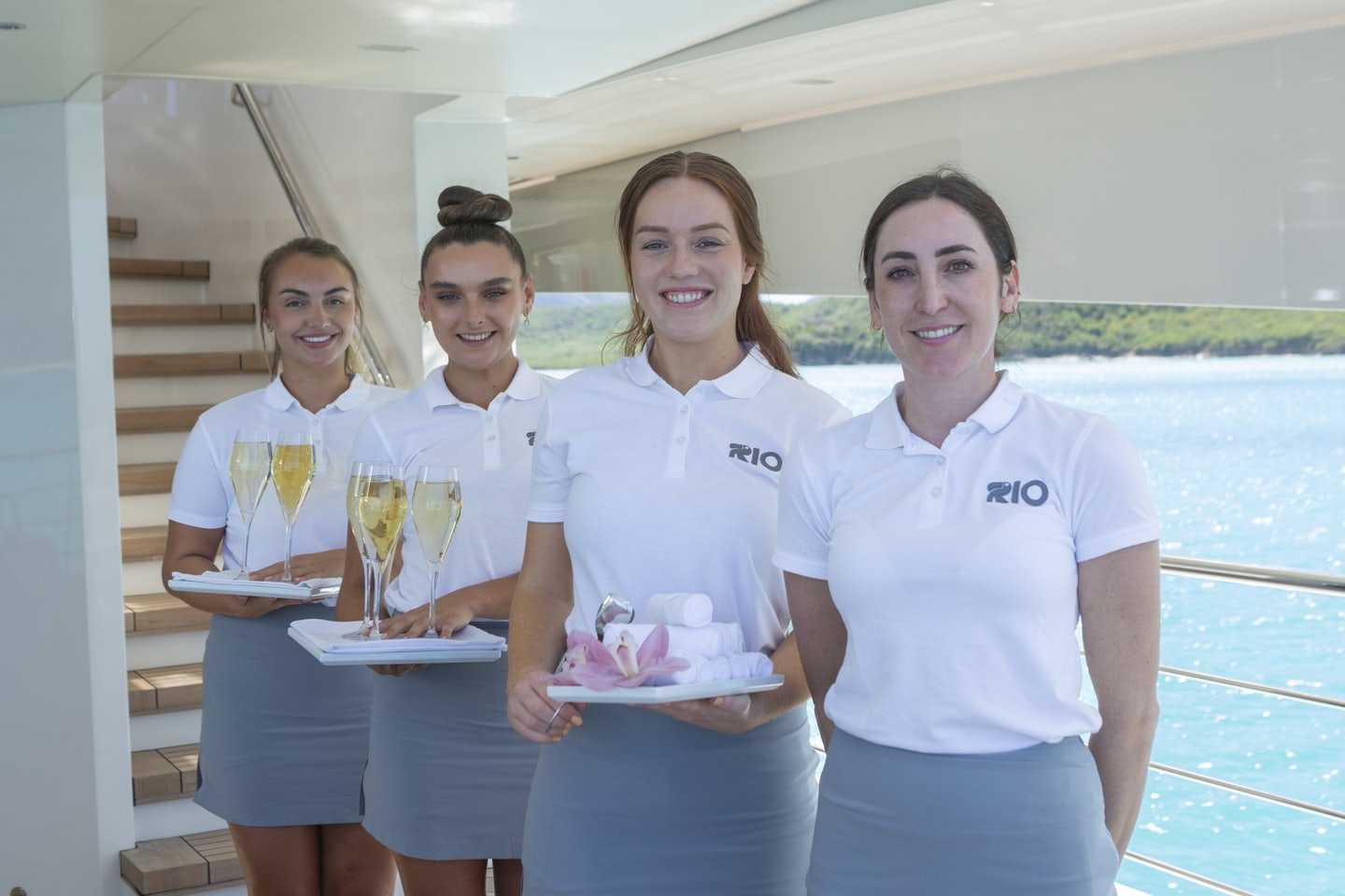 a group of people holding wine glasses aboard RIO Yacht for Charter