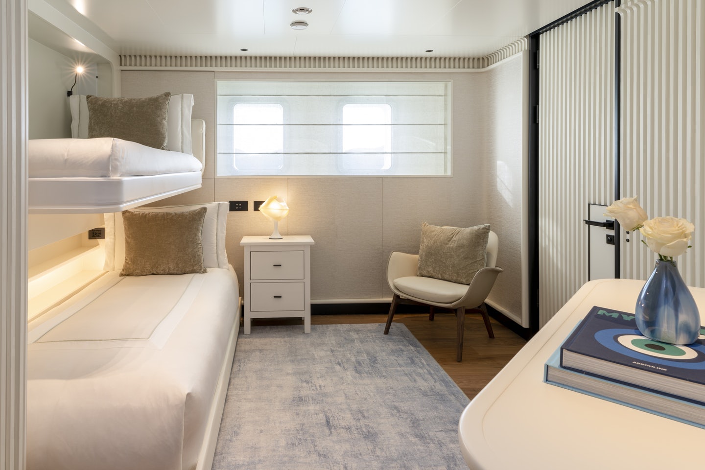 a room with a bed and a desk aboard RIO Yacht for Charter