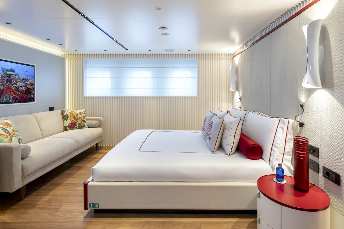a living room with a white couch and a red coffee table aboard RIO Yacht for Charter