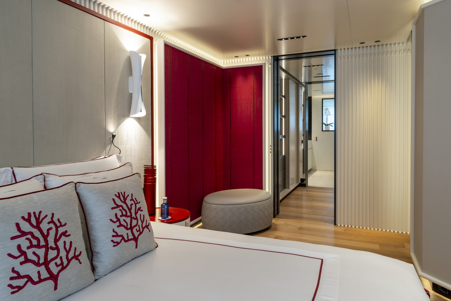 a bed with a red curtain aboard RIO Yacht for Charter