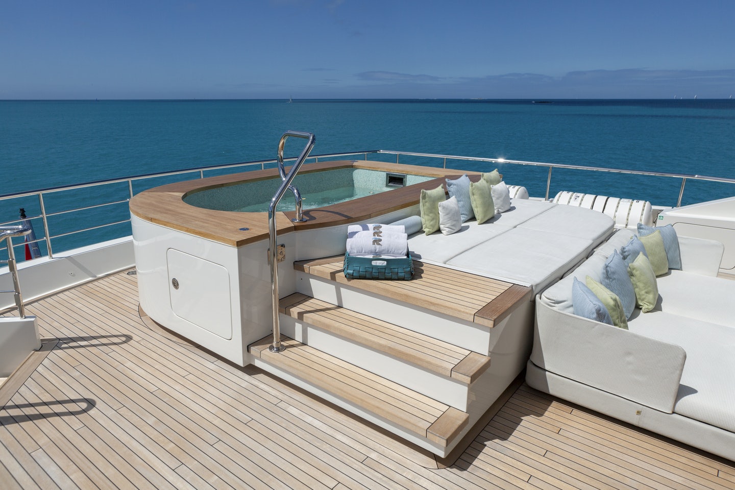 a white bed on a deck aboard RIO Yacht for Charter