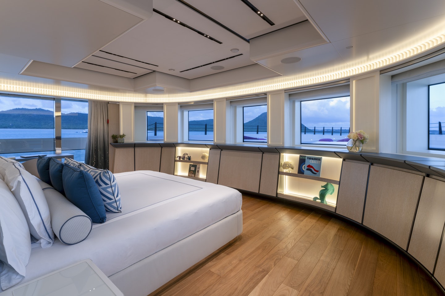 a living room with a couch and a large window aboard RIO Yacht for Charter