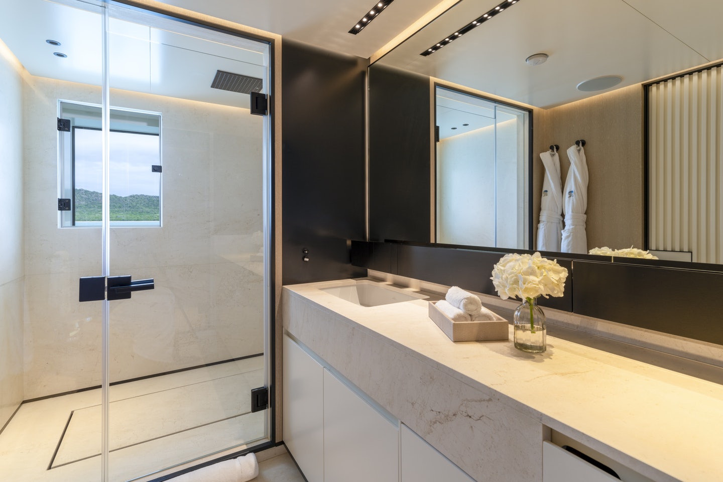 a bathroom with a glass shower aboard RIO Yacht for Charter