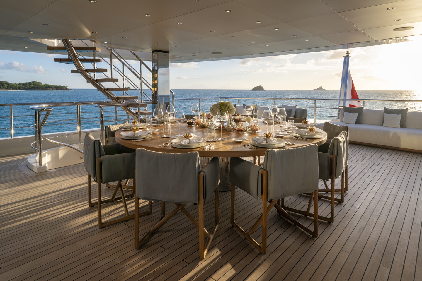 a table set for a meal on a deck overlooking the ocean aboard RIO Yacht for Charter