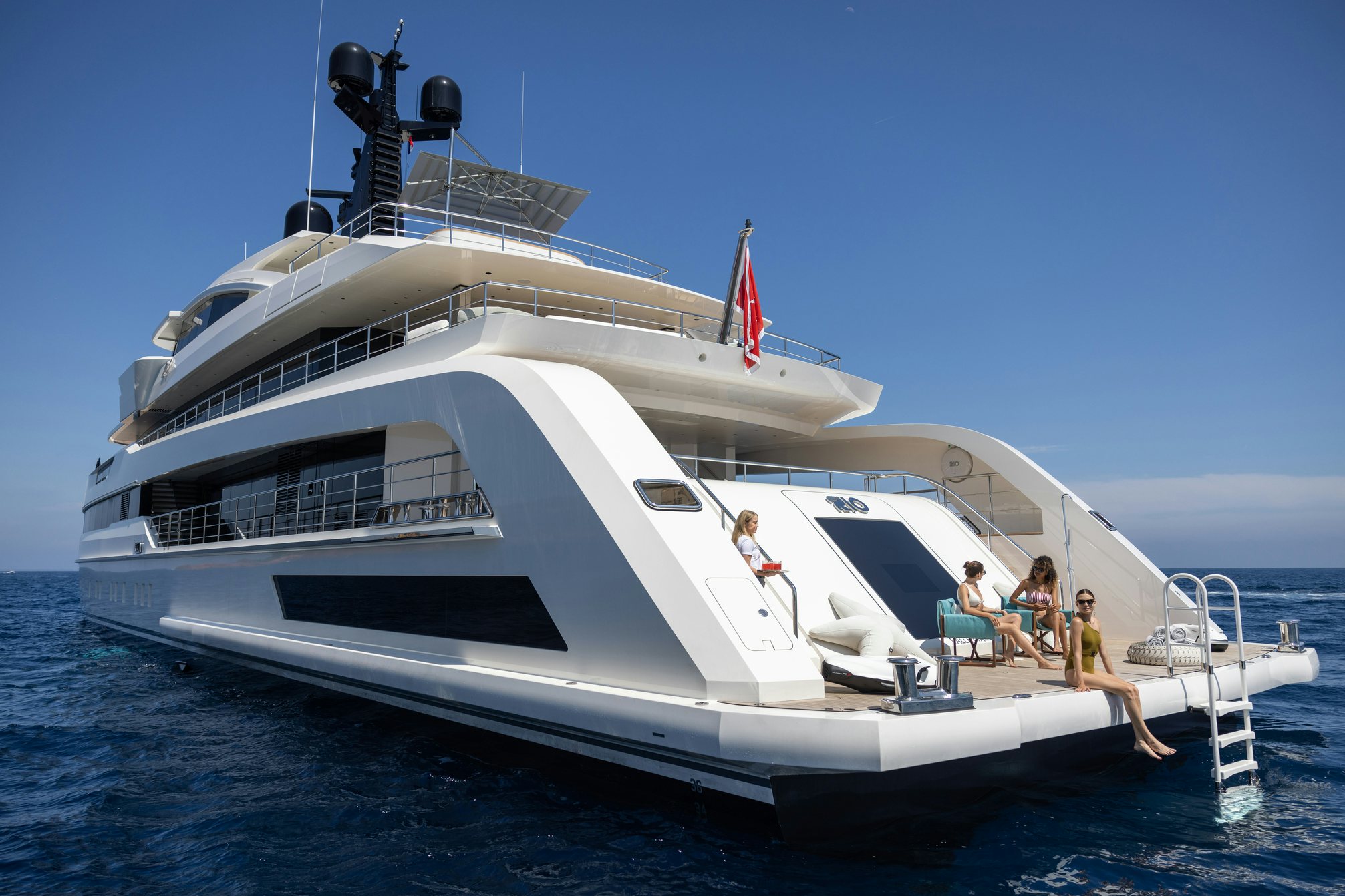 a white yacht with people on it aboard RIO Yacht for Charter