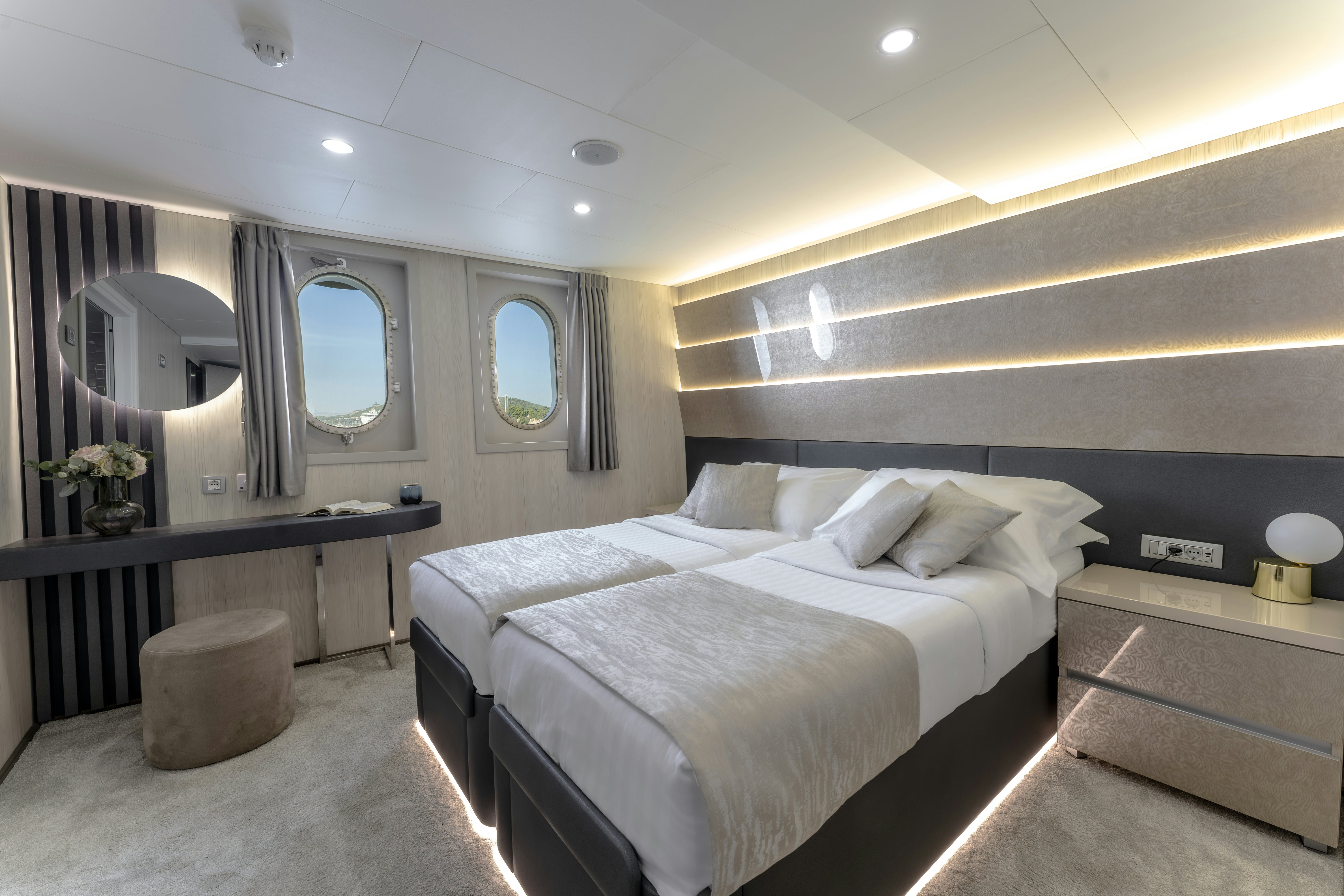 a bedroom with a large mirror aboard CRISTAL Yacht for Charter