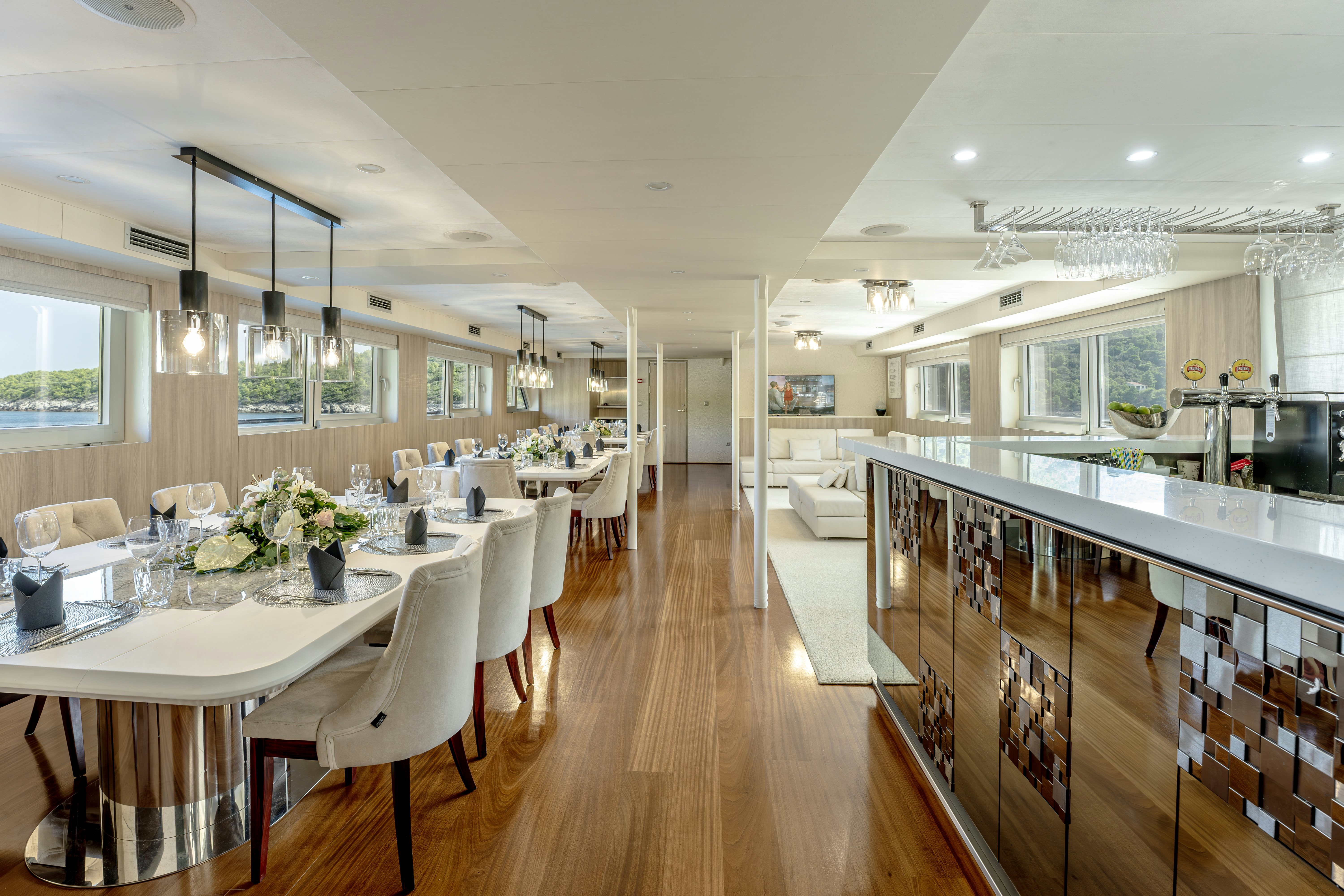 a large kitchen with a dining table aboard CRISTAL Yacht for Charter