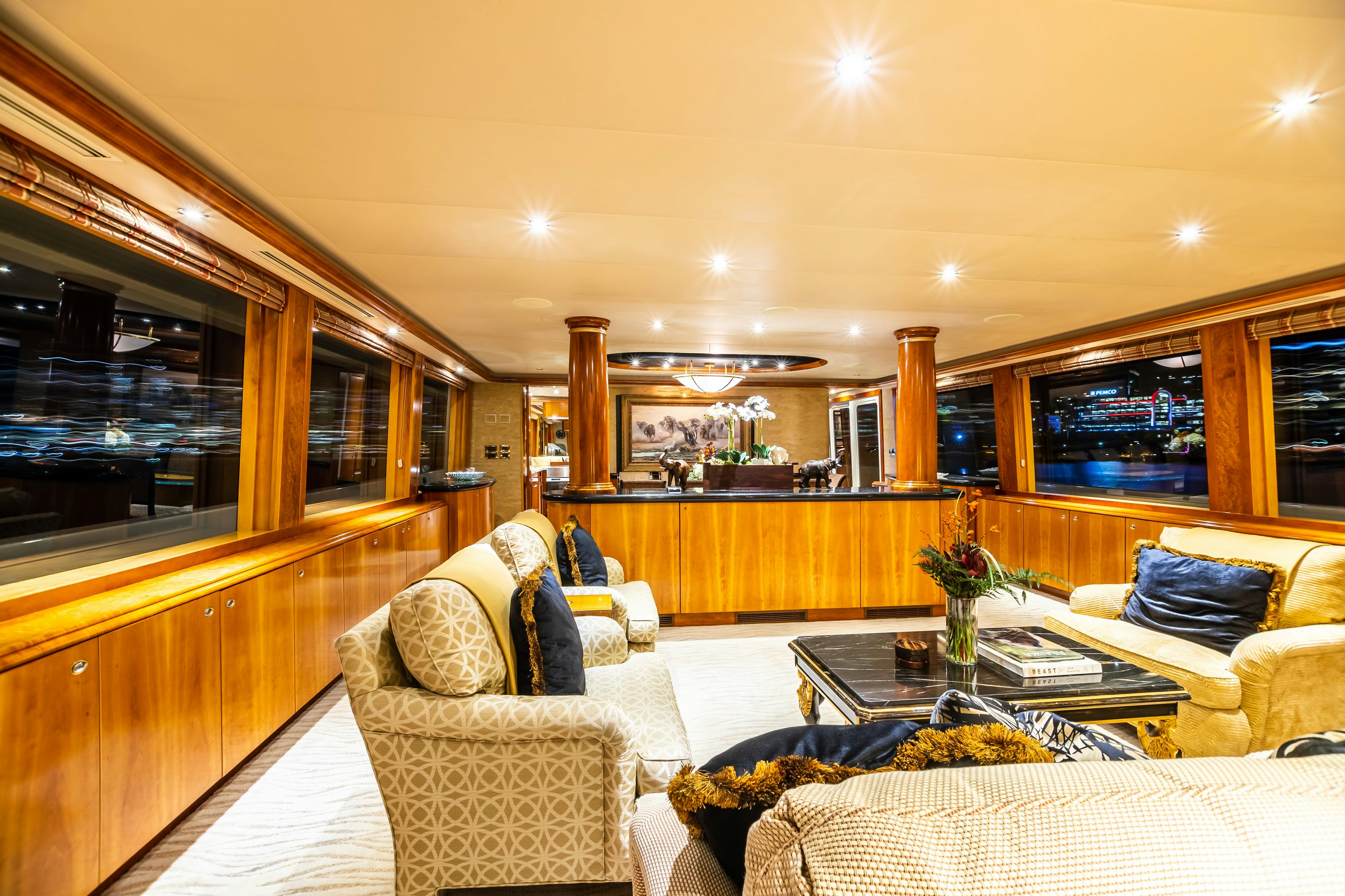 a living room with a couch and a coffee table aboard SERENGETI Yacht for Charter