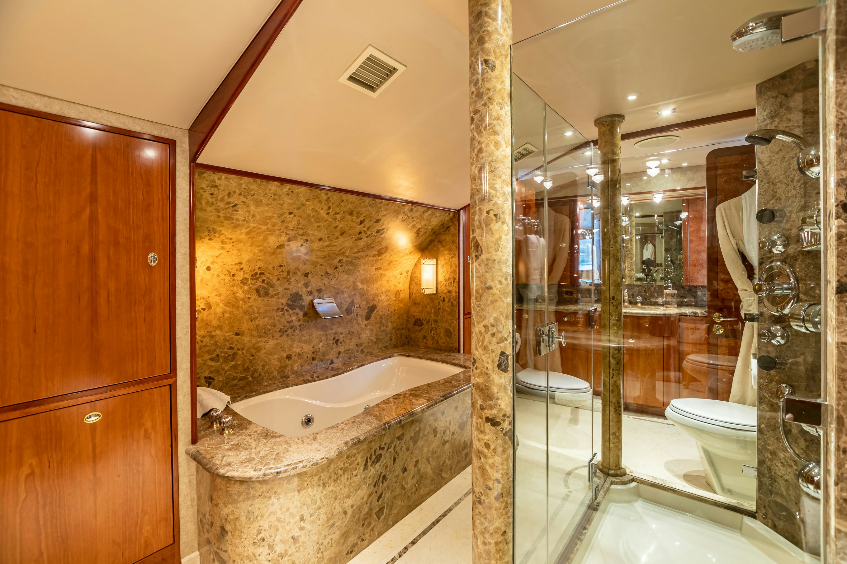 a bathroom with a bathtub and shower aboard SERENGETI Yacht for Charter