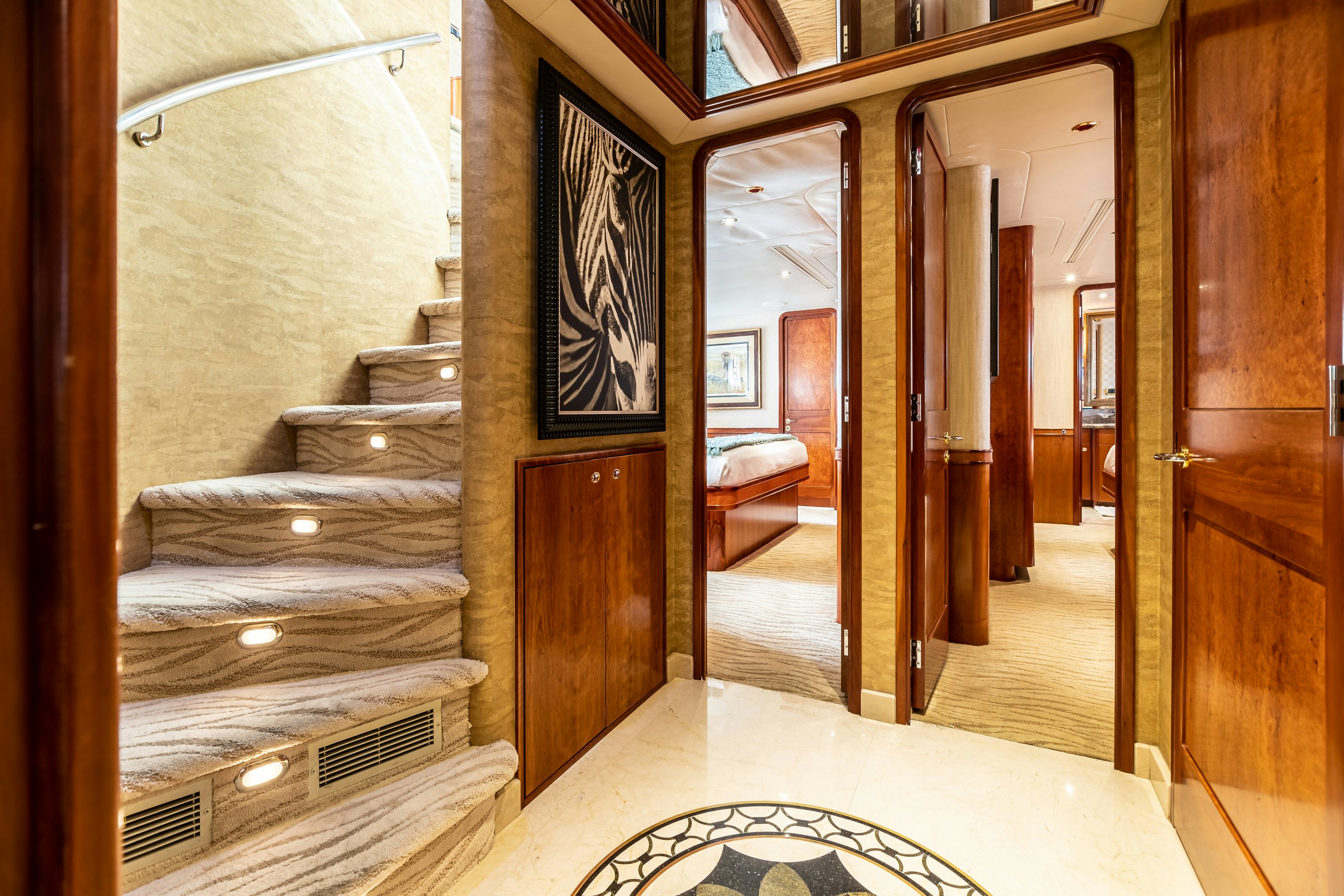 a room with a bed and a door aboard SERENGETI Yacht for Charter