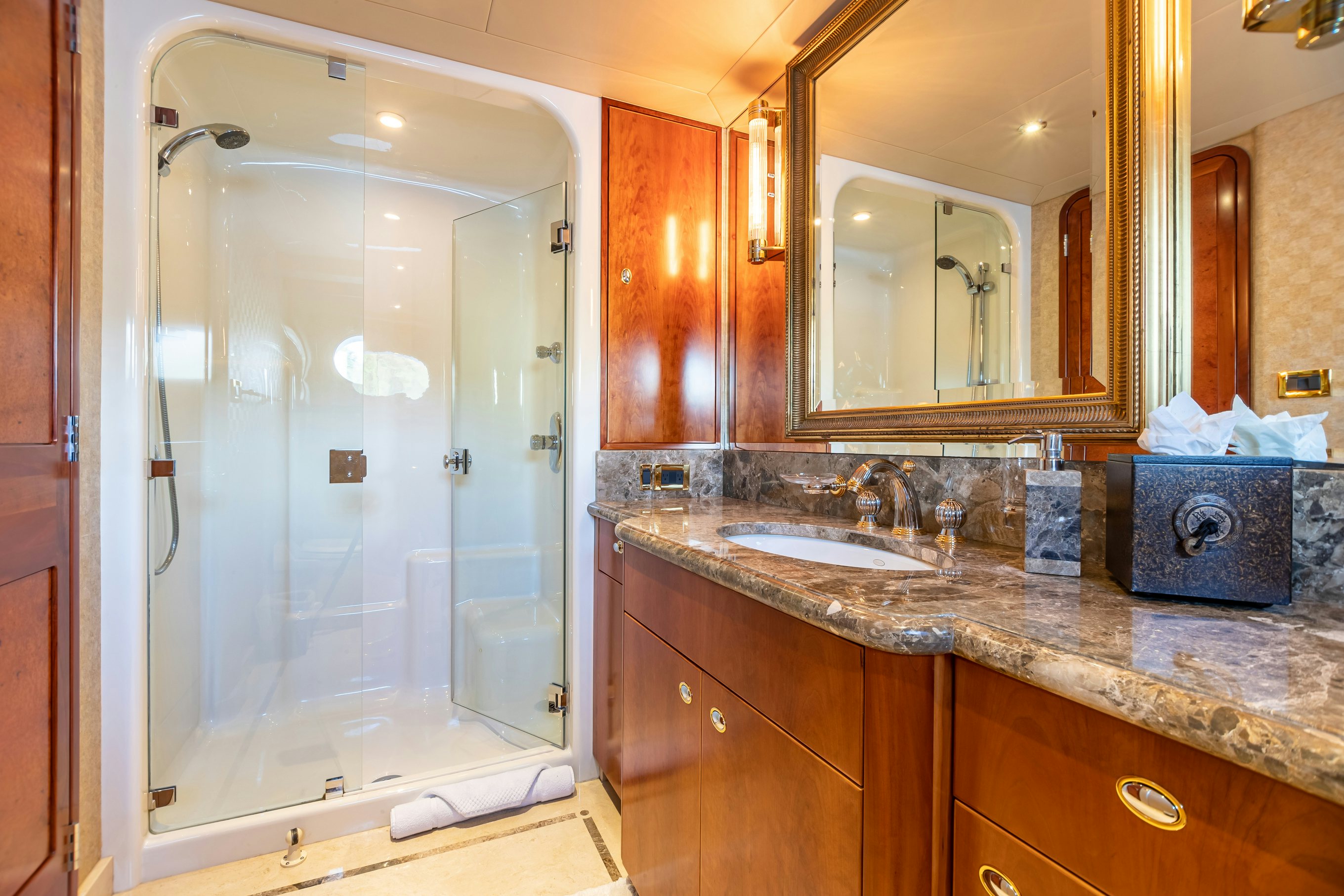 a bathroom with a glass shower aboard SERENGETI Yacht for Charter