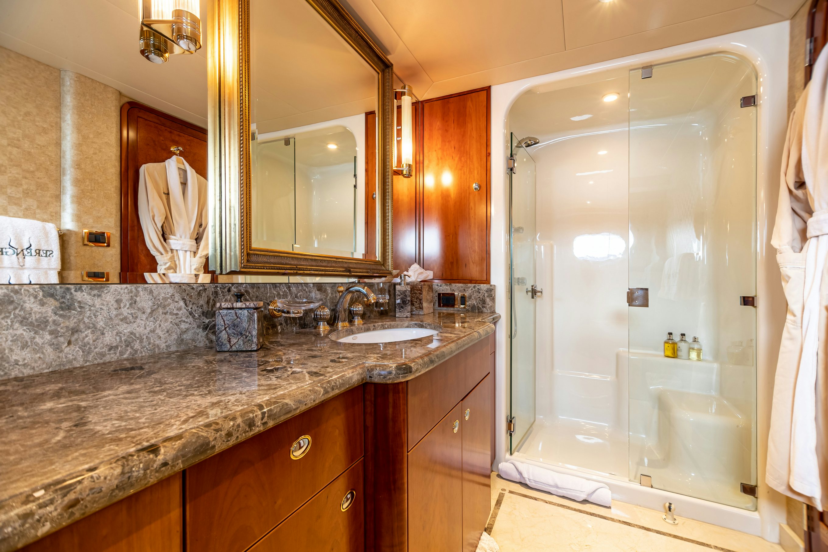 a bathroom with a large glass shower aboard SERENGETI Yacht for Charter