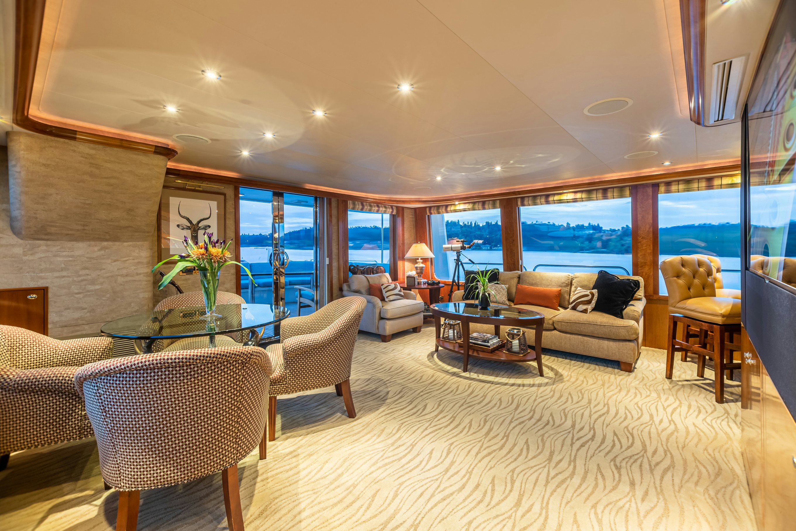 a living room with a large window aboard SERENGETI Yacht for Charter