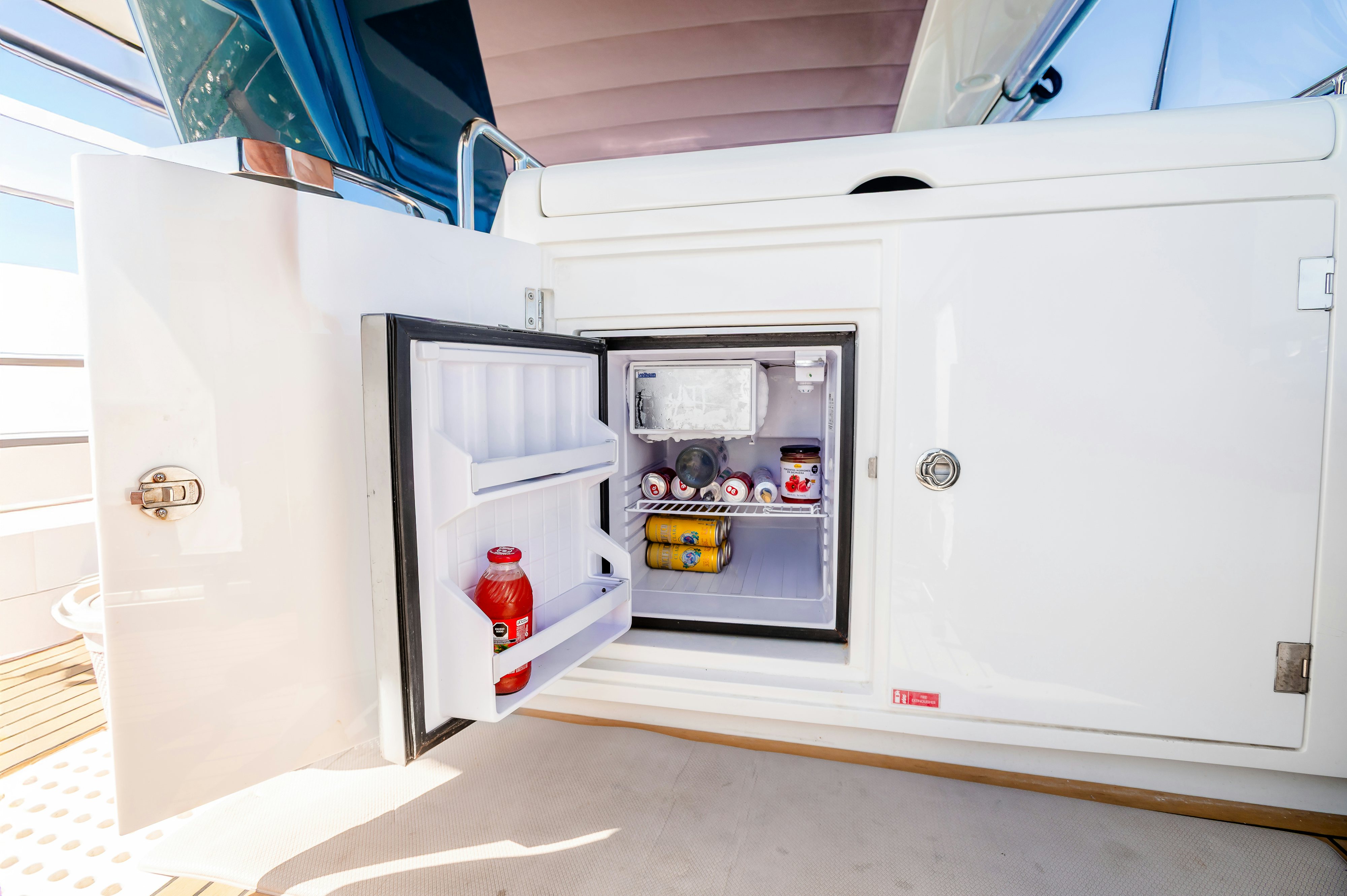 a small refrigerator with a door open aboard VIAKAREY Yacht for Sale