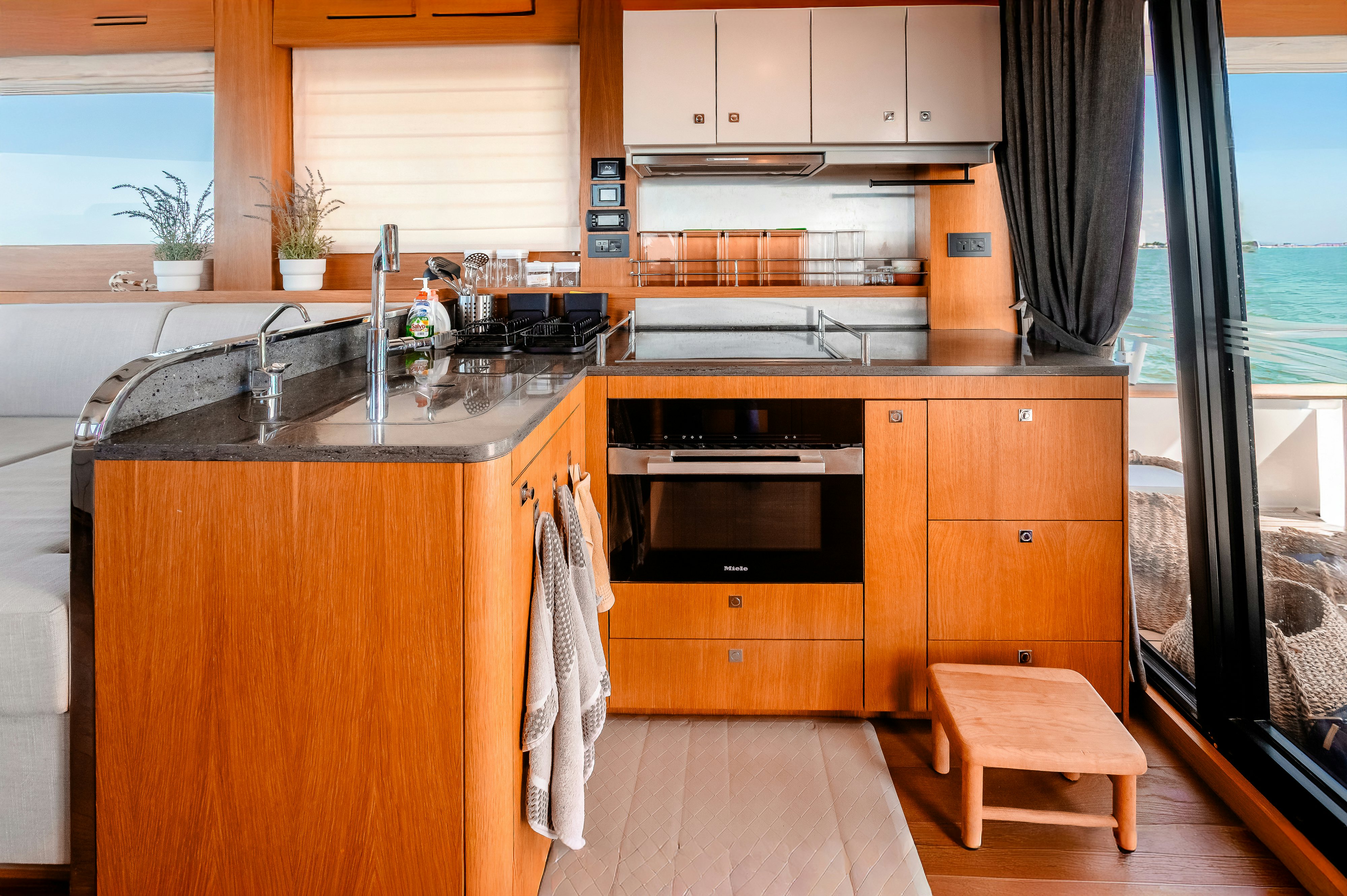a kitchen with wooden cabinets aboard VIAKAREY Yacht for Sale