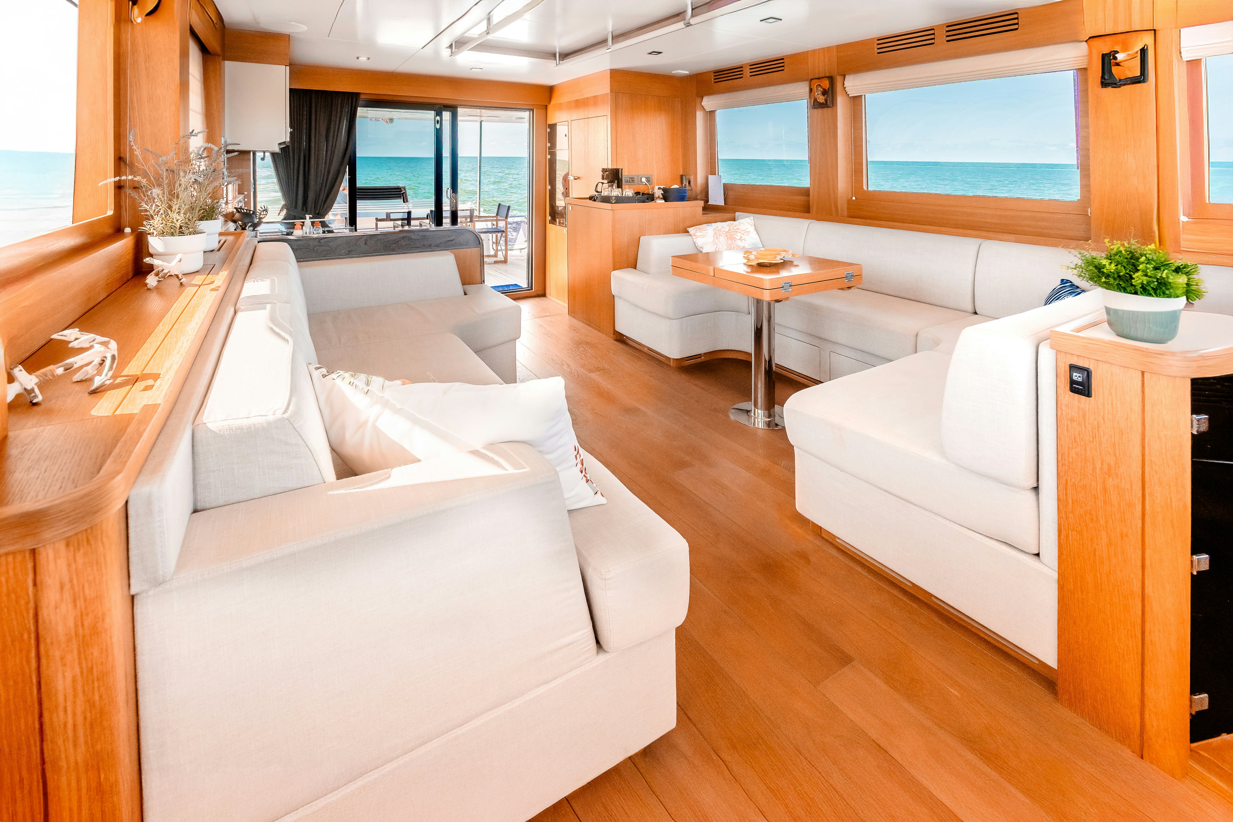 a living room with a couch and a table aboard VIAKAREY Yacht for Sale