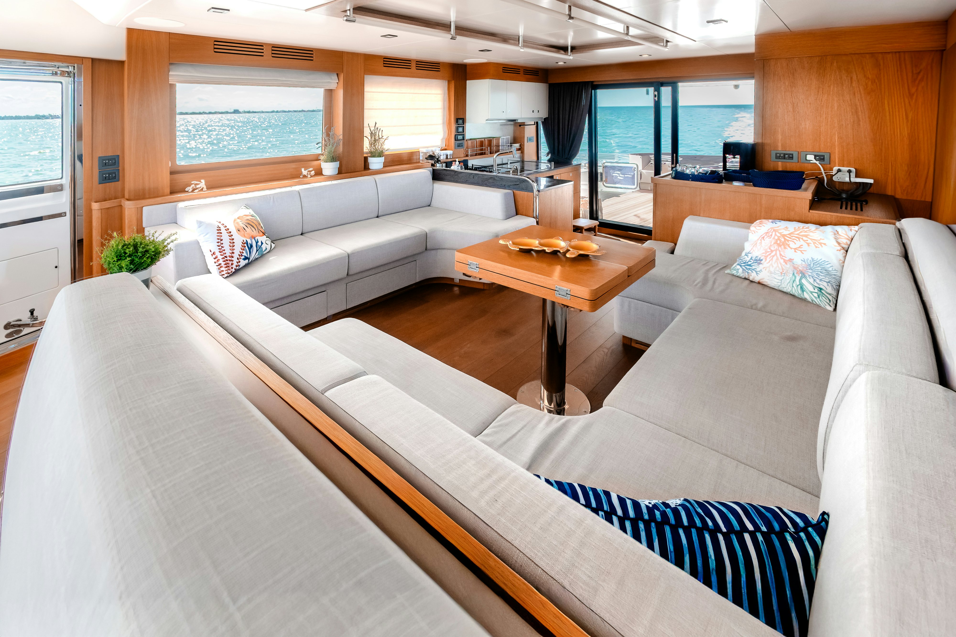 a living room with a couch and a coffee table aboard VIAKAREY Yacht for Sale
