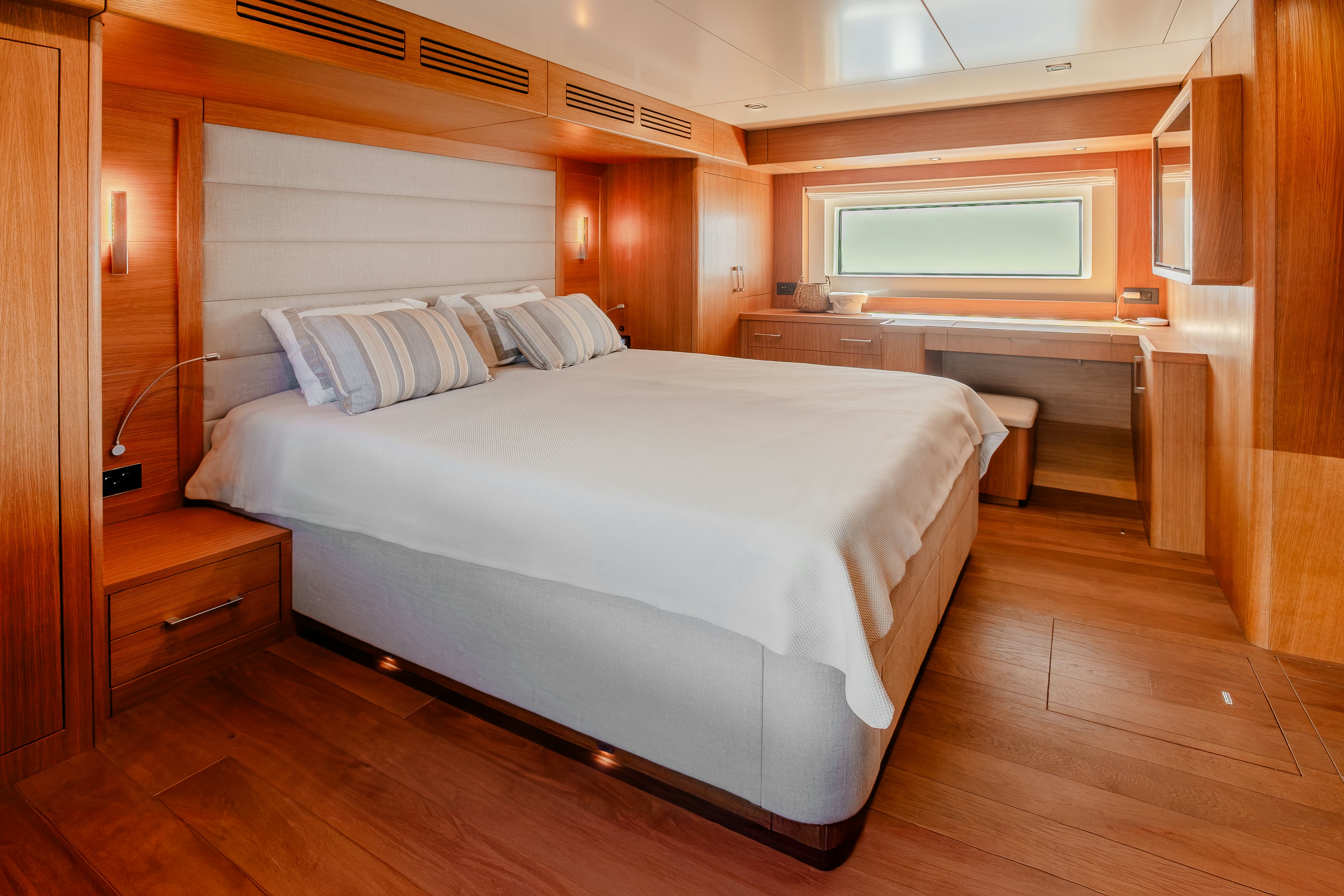 a bedroom with a large bed aboard VIAKAREY Yacht for Sale