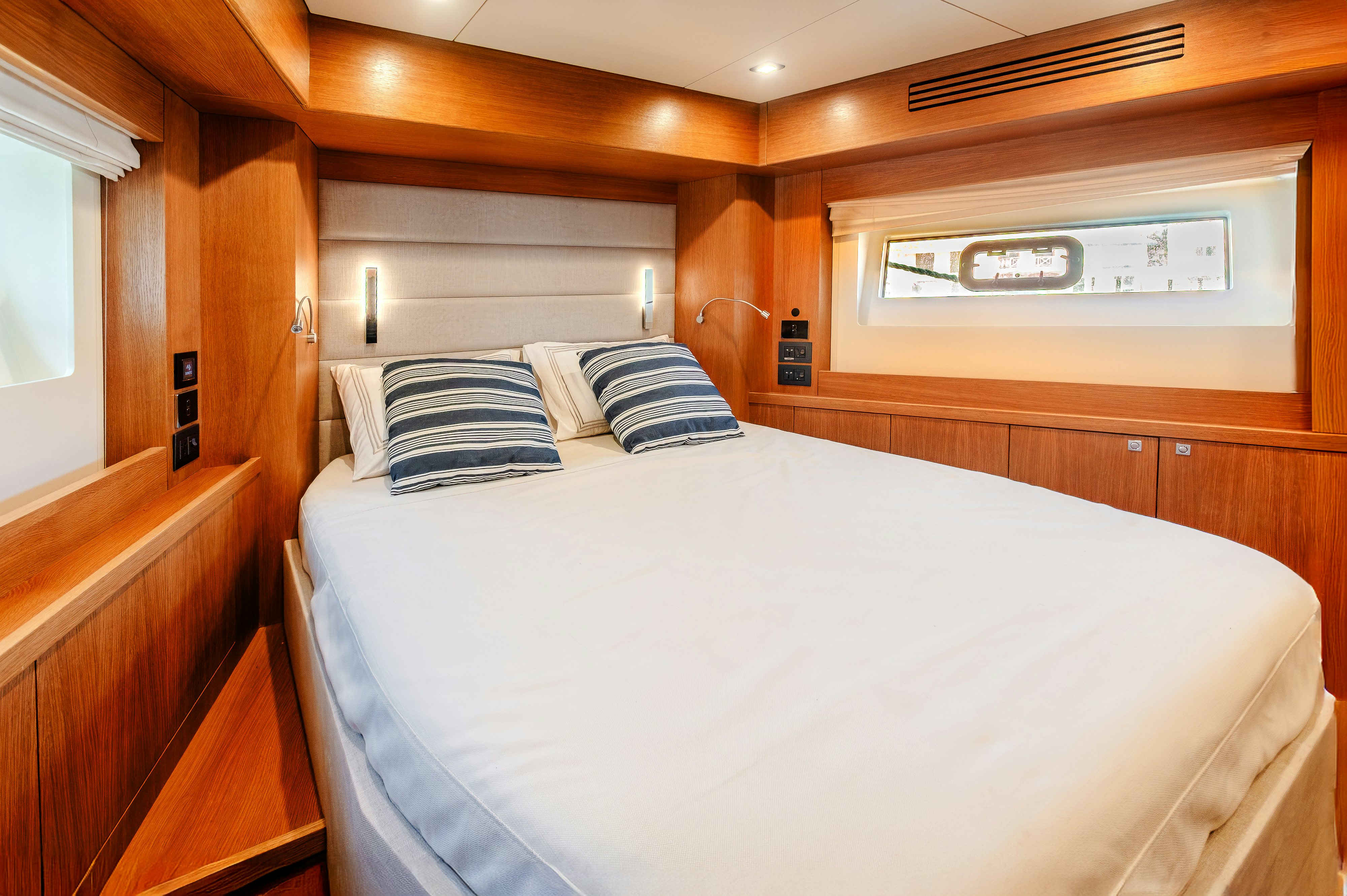 a bed with white sheets and pillows aboard VIAKAREY Yacht for Sale