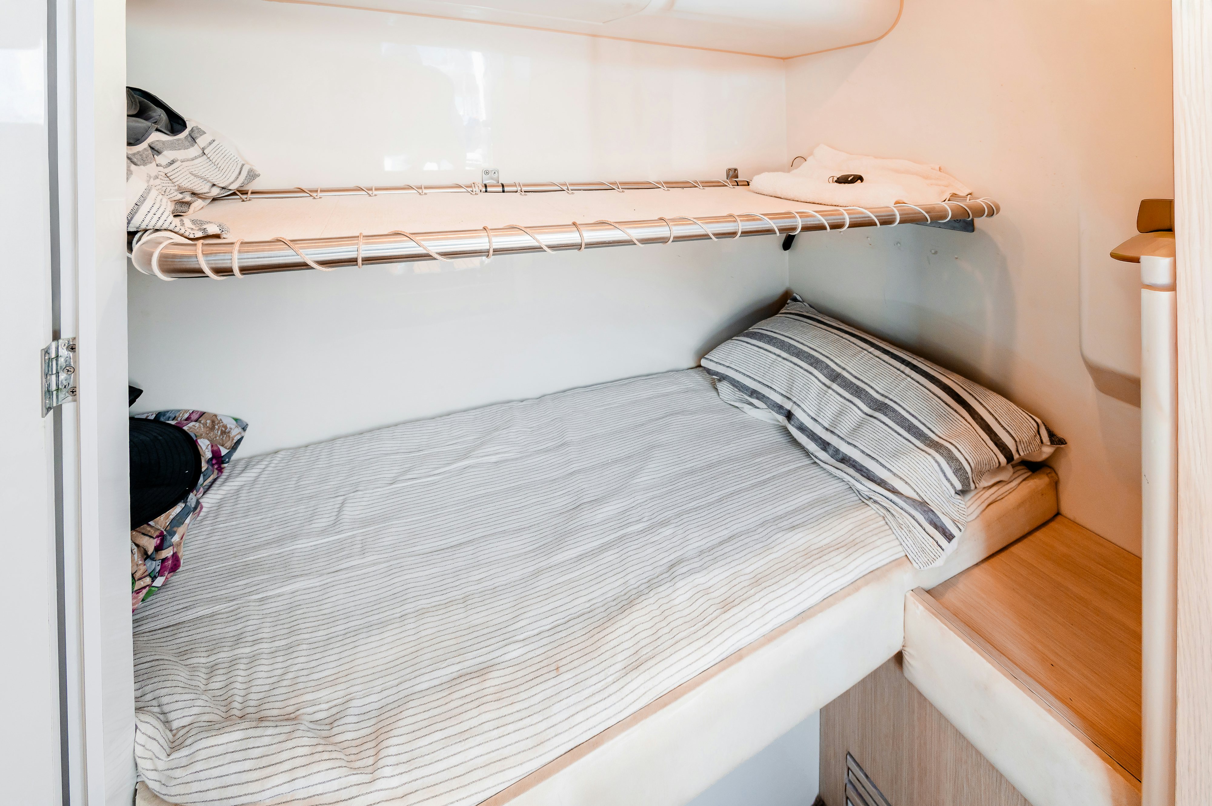a bed with a white sheet aboard VIAKAREY Yacht for Sale